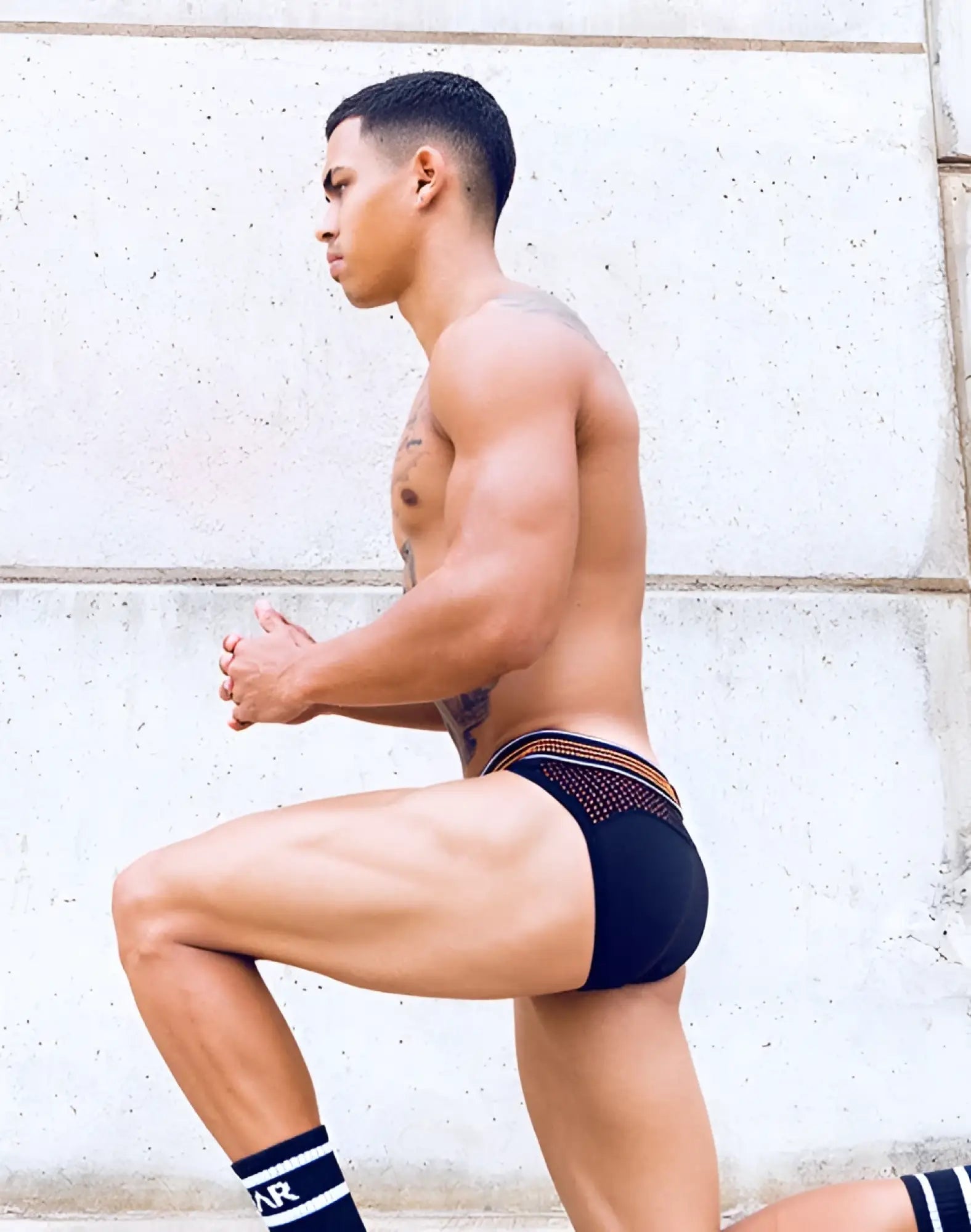 Black briefs with neon orange trim and breathable mesh panel from supawear neon mesh brief underwear collection