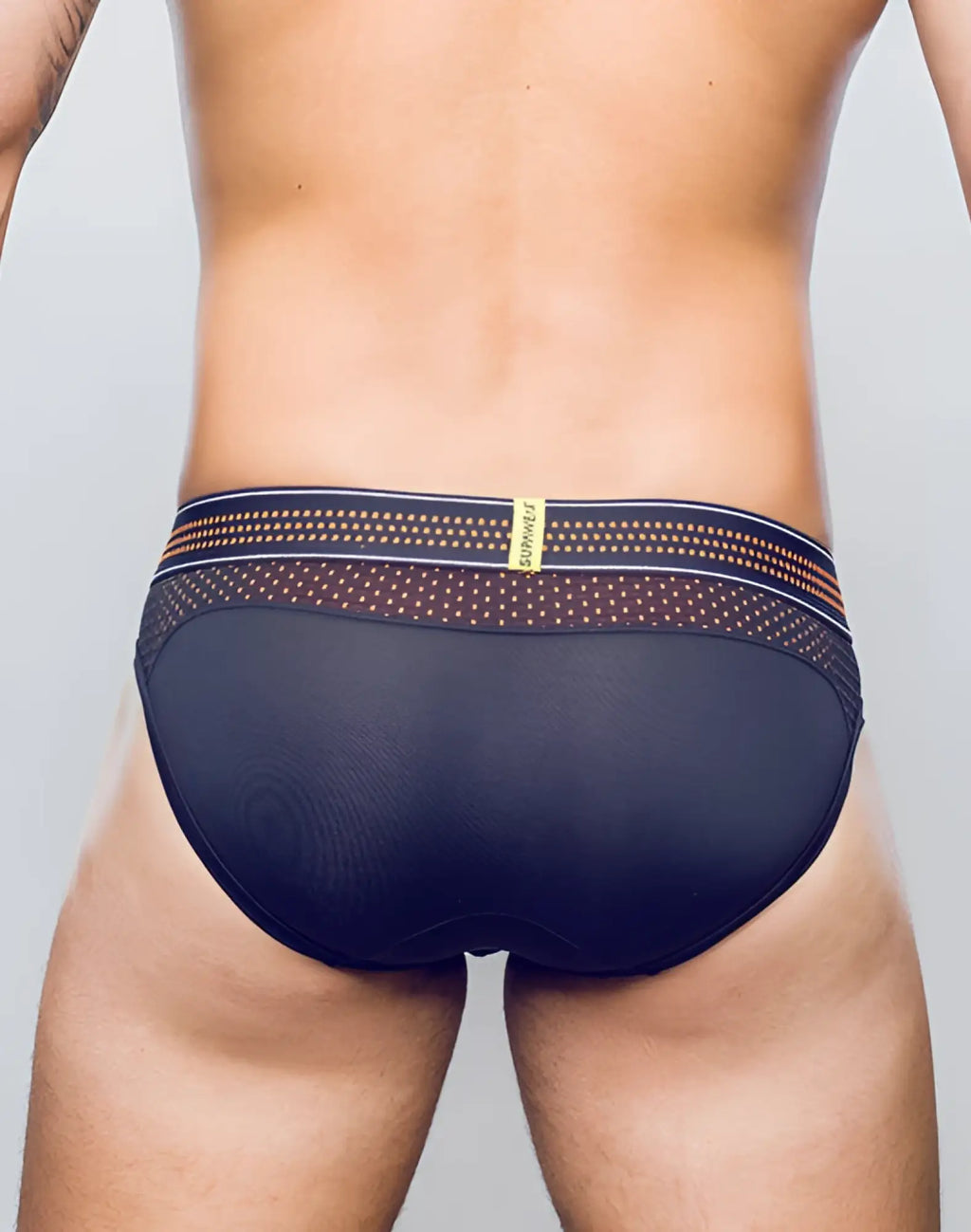 Black mesh SUPAWEAR neon mesh brief underwear in neon orange with patterned waistband featuring gold and navy accents