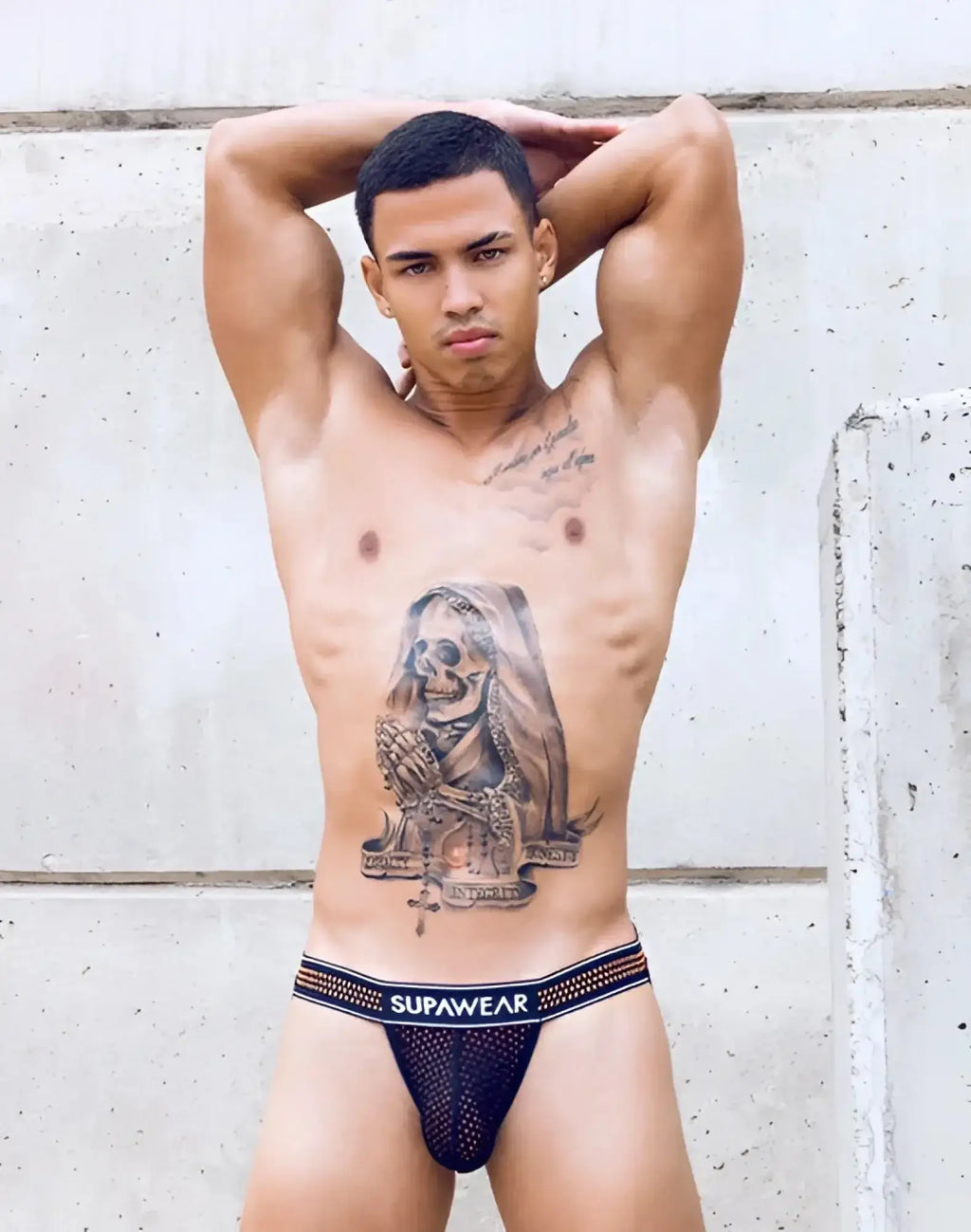 Black mesh supawear briefs with white elastic waistband featuring SUPAWEAR branding in neon orange mesh jockstrap style