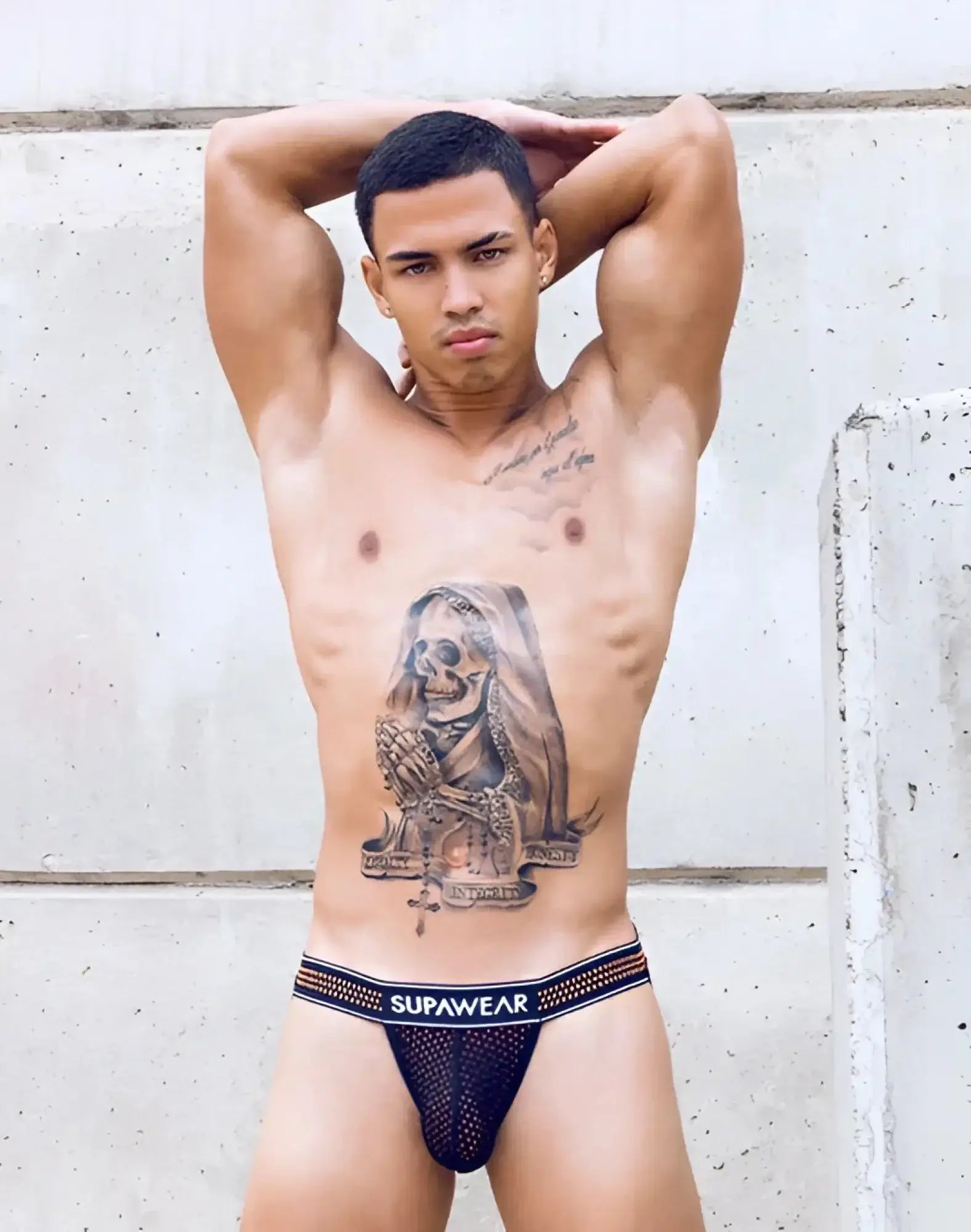 Black mesh supawear briefs with white elastic waistband featuring SUPAWEAR branding in neon orange mesh jockstrap style