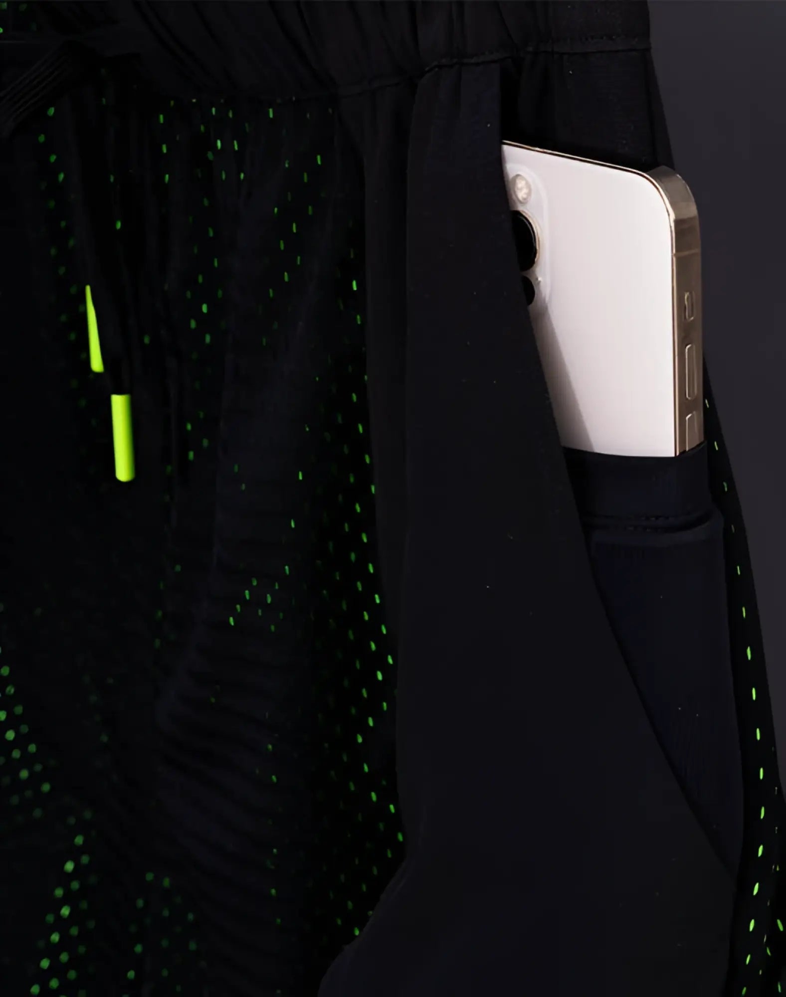 SupaWear neon mesh shorts in black with a subtle green dot pattern and neon green drawstring for athletic use