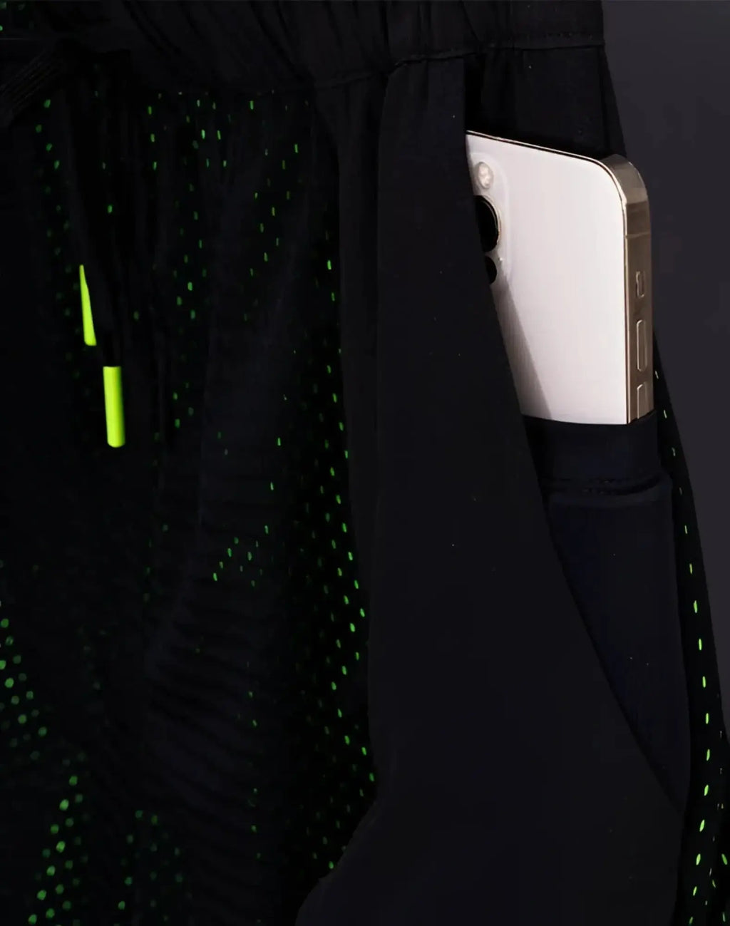 SupaWear neon mesh shorts in black with a subtle green dot pattern and neon green drawstring for athletic use