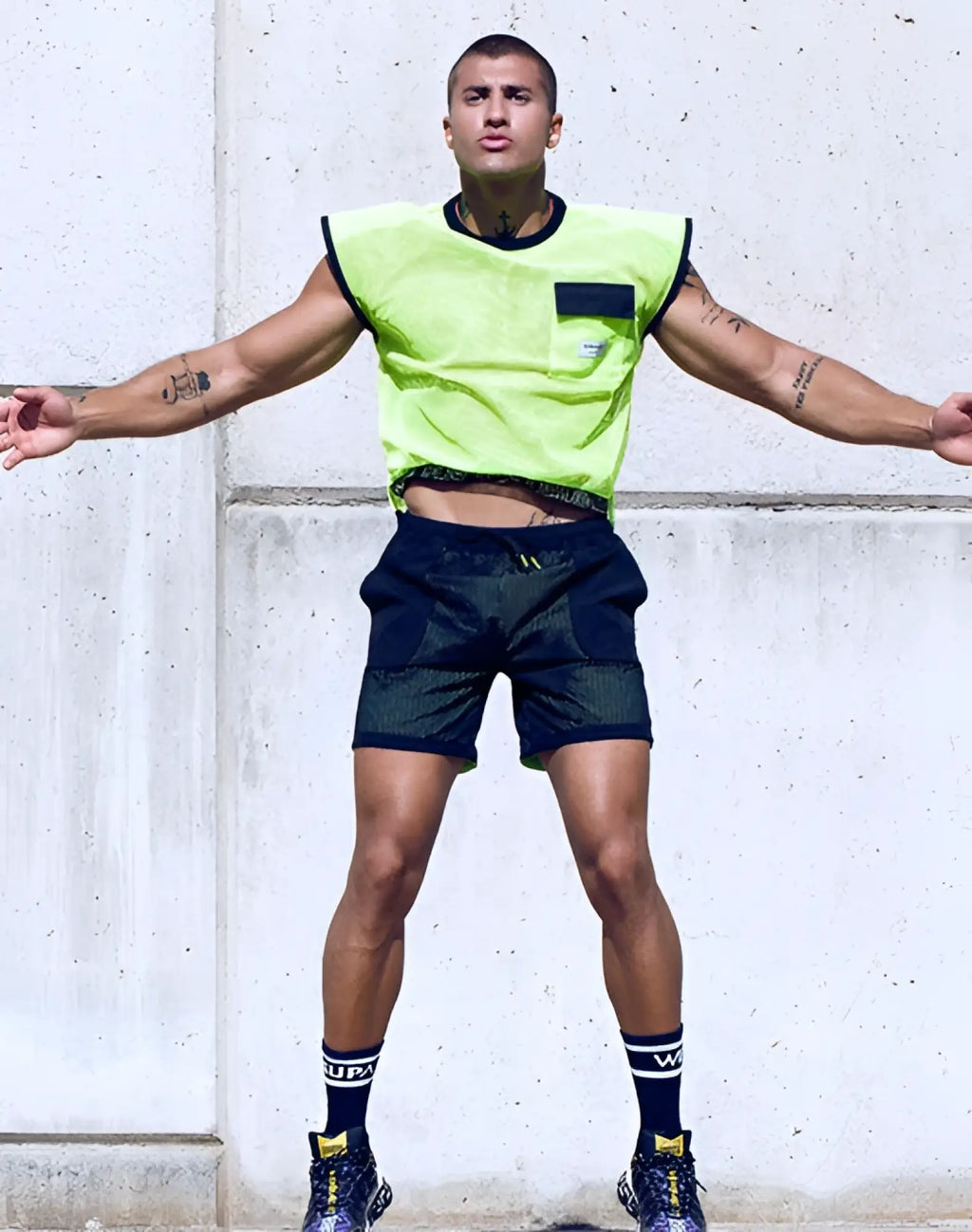 Supawear neon mesh sleeveless athletic top in neon green with black trim and front pocket for activewear