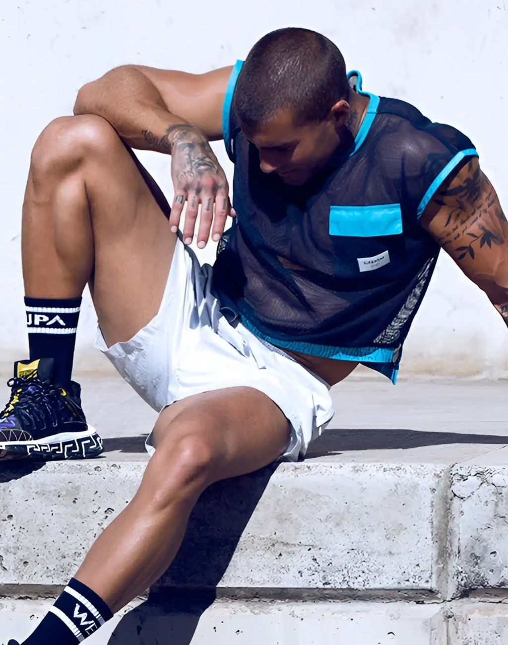 Black mesh sleeveless SUPAWEAR neon top with turquoise trim and matching pocket in navy blue color