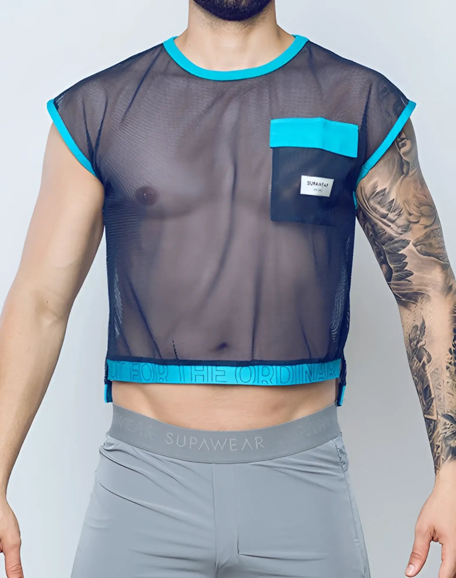A navy blue mesh crop top with turquoise trim and front pocket featuring supawear branding on the waistband
