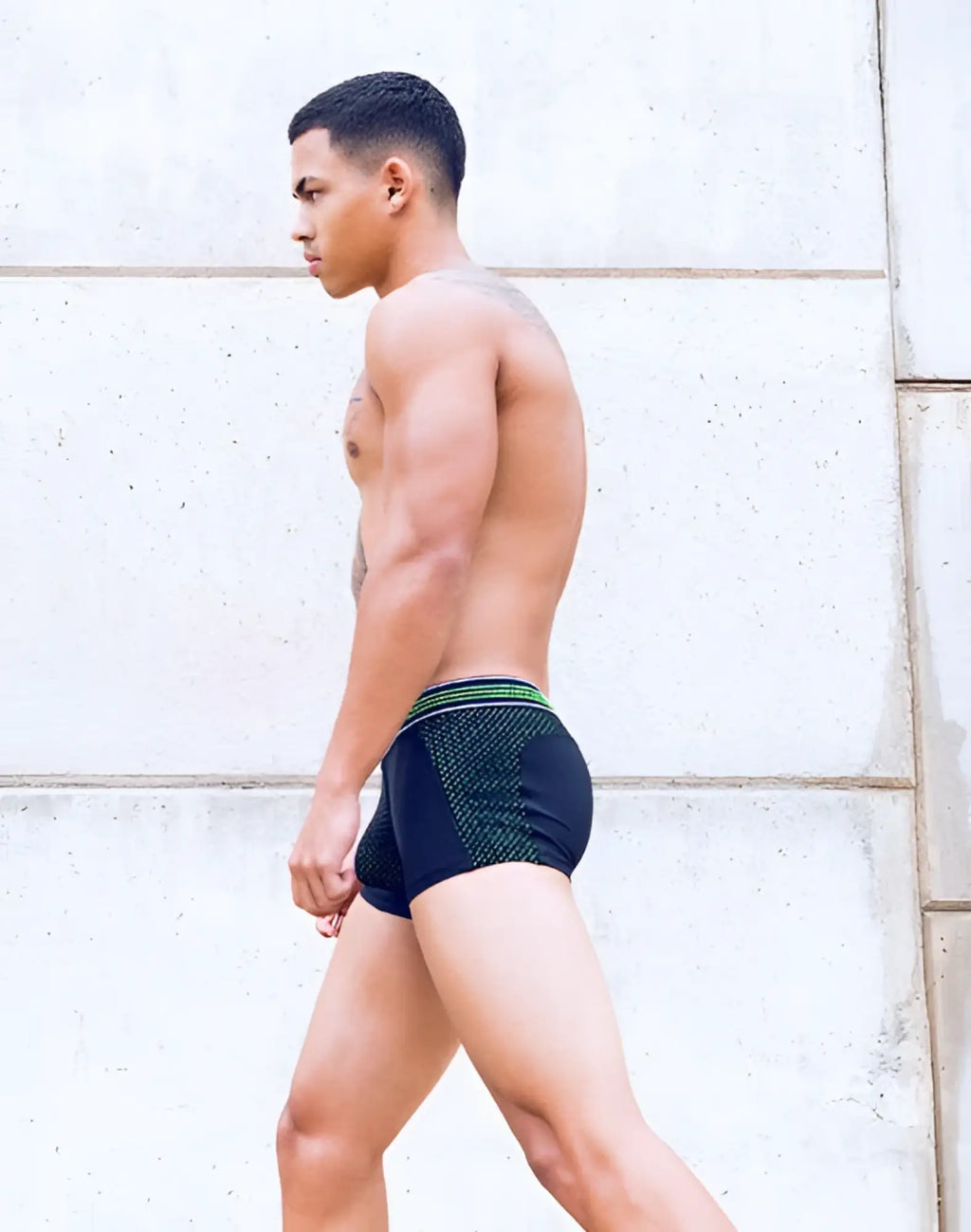 Black SUPAWEAR neon mesh trunk underwear with green and white patterned waistband for athletic use front view