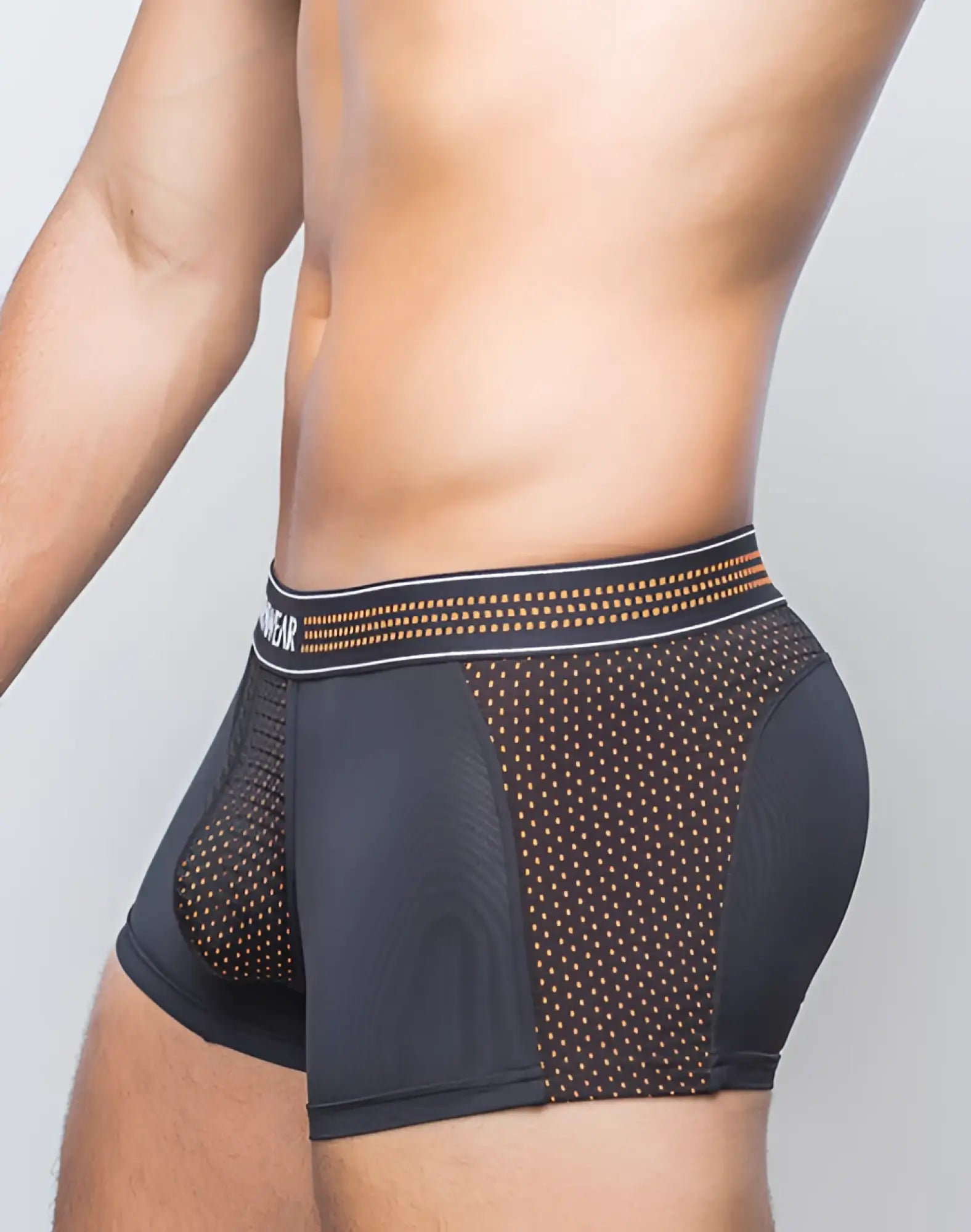 Black supawear neon mesh trunk underwear with perforated mesh and gold dot accents on the waistband in neon orange