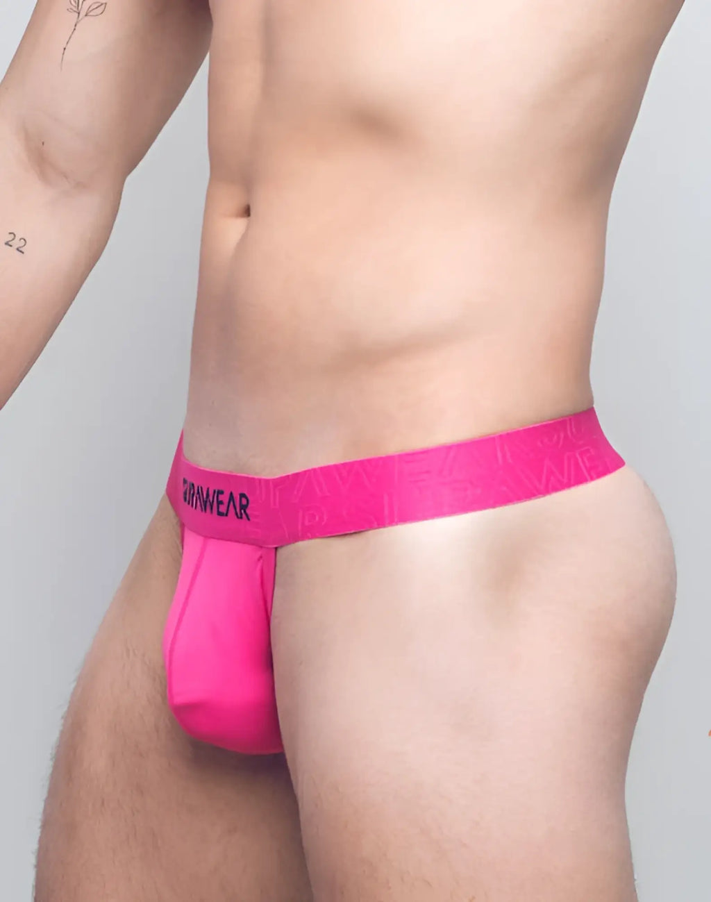 Bright pink seamless SUPAWEAR neon thong underwear with matching waistband featuring rarewear brand name in black lettering