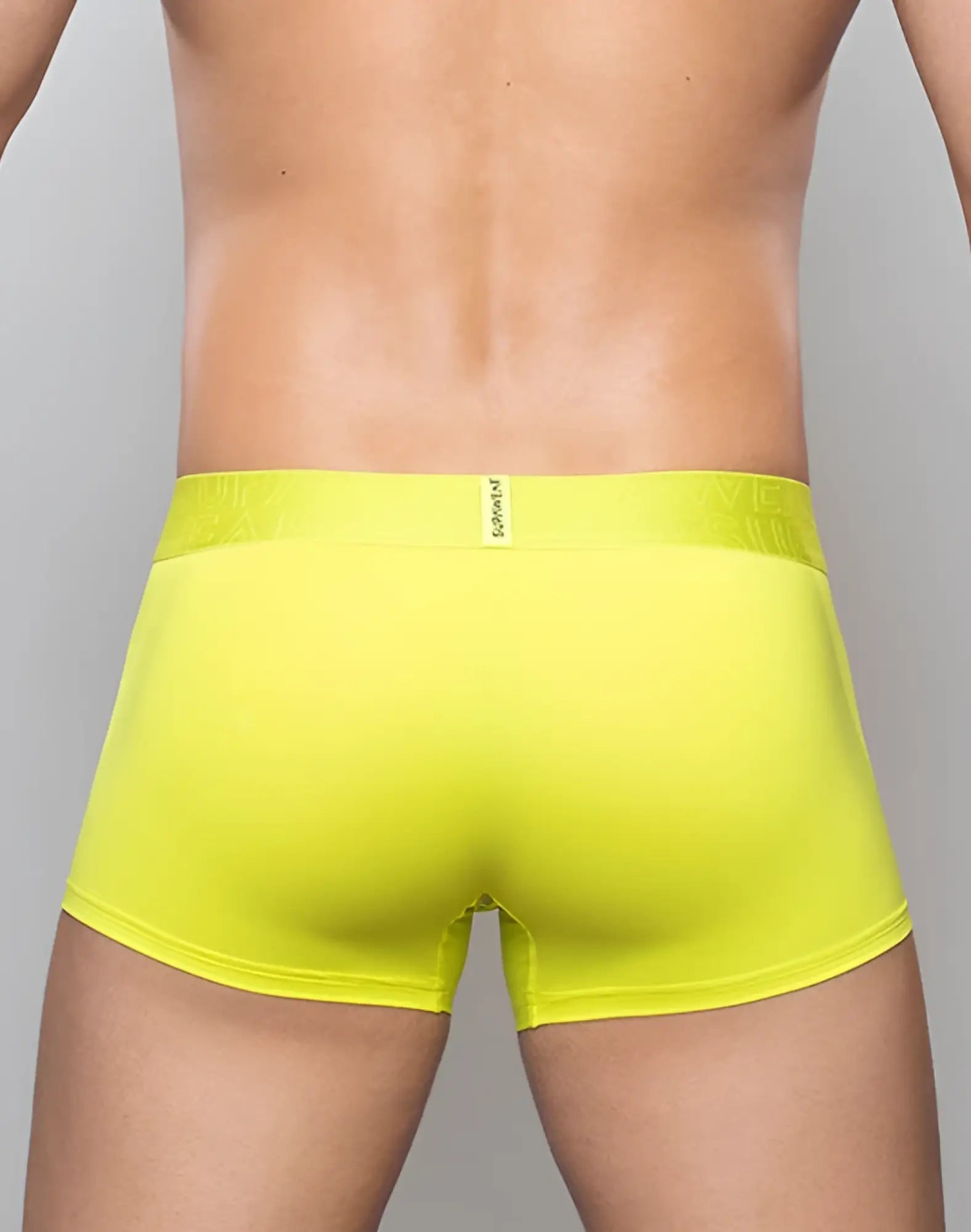 Bright yellow supawear neon trunk underwear with textured waistband and small brand tag in cyber lime color