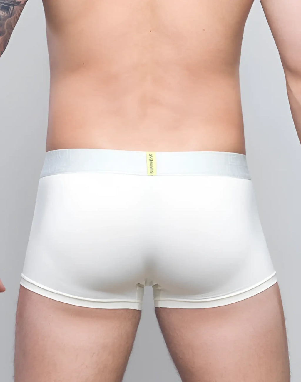 White mens briefs with a light gray waistband featuring supawear in yellow neon text in ivory neon trunk underwear