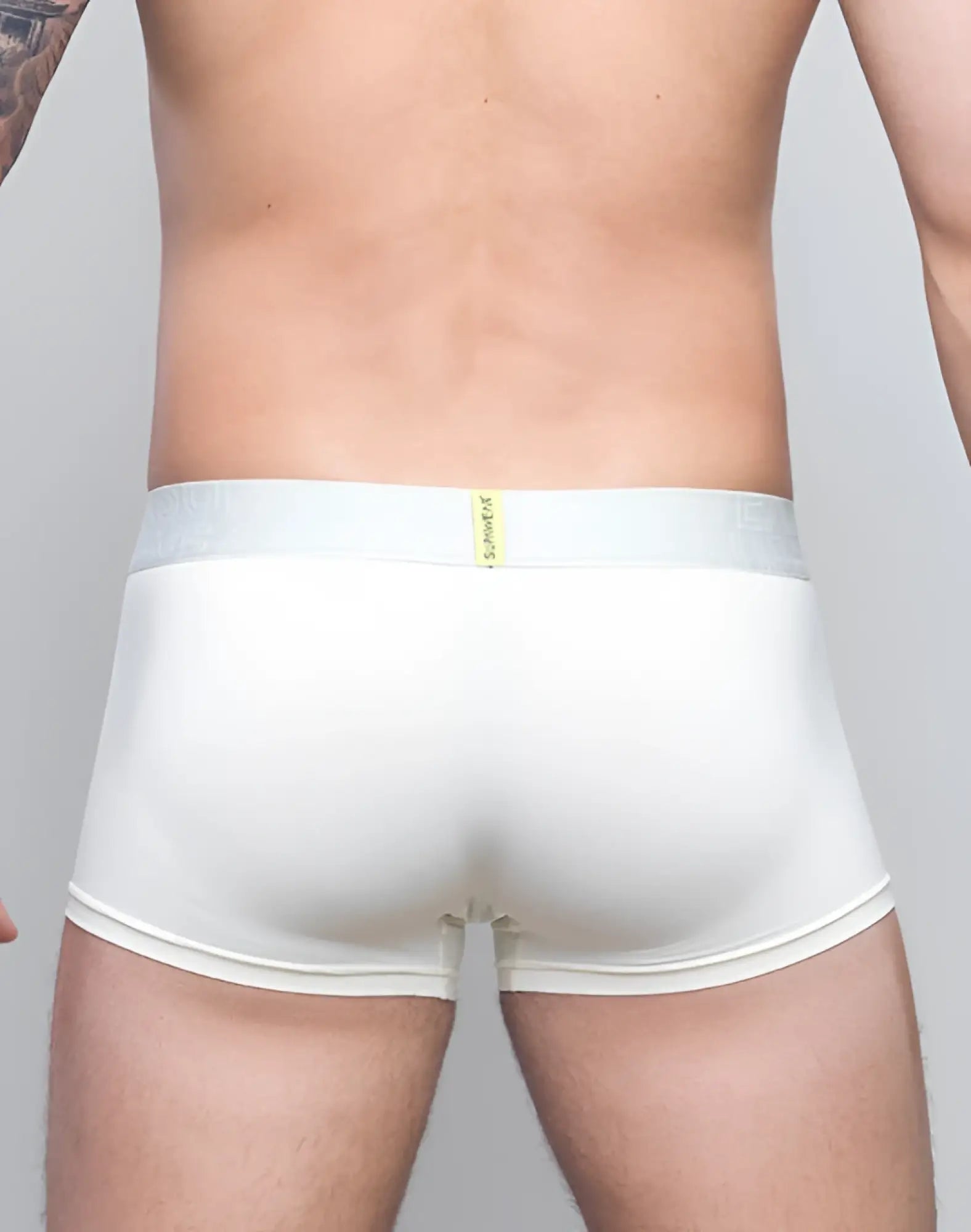 White mens briefs with a light gray waistband featuring supawear in yellow neon text in ivory neon trunk underwear