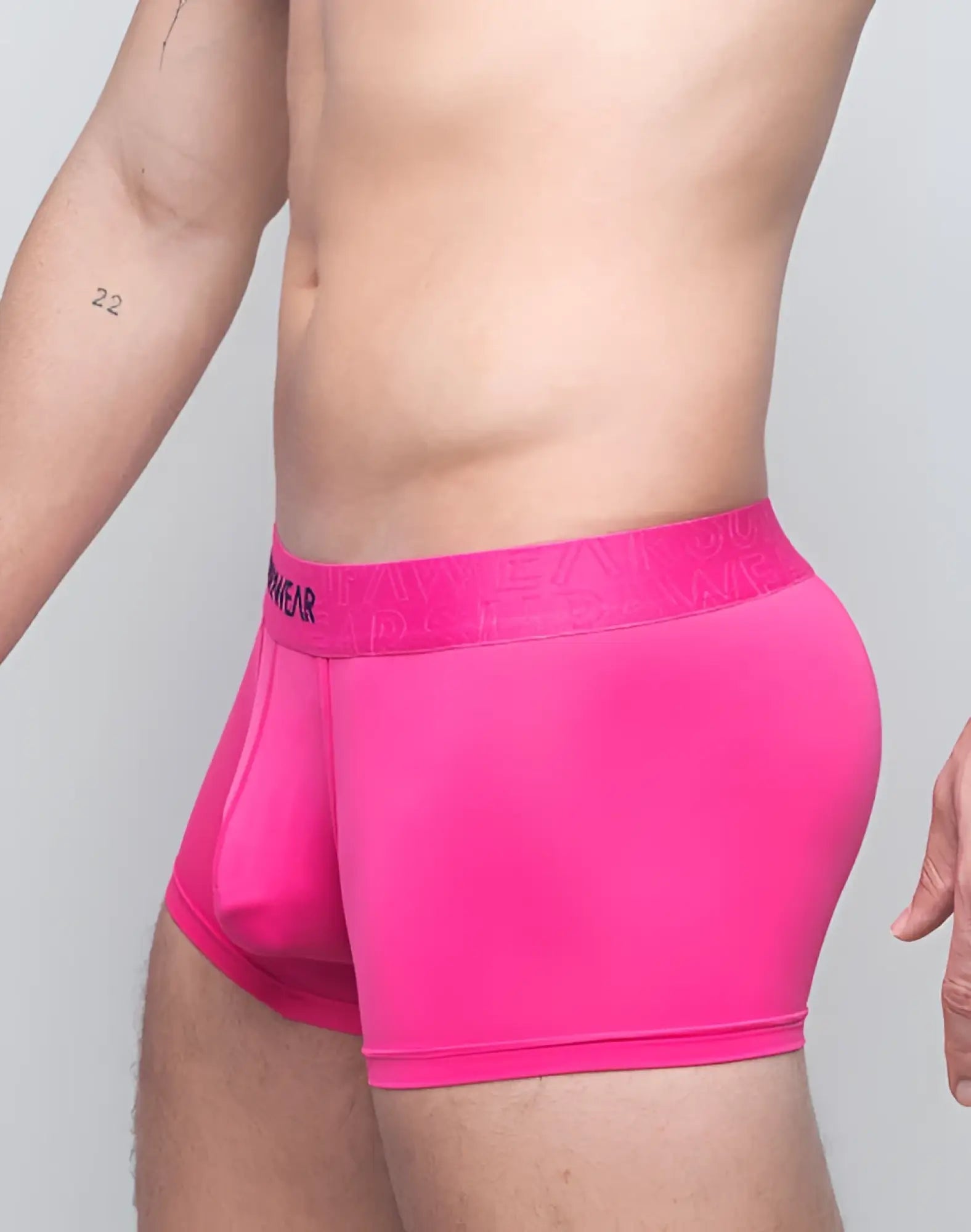 Bright pink supawear neon trunk underwear with matching elastic waistband featuring menwear branding in black lettering