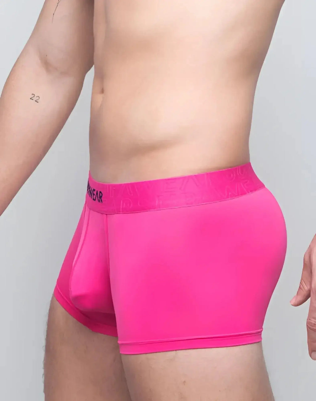 Bright pink supawear neon trunk underwear with matching elastic waistband featuring menwear branding in black lettering