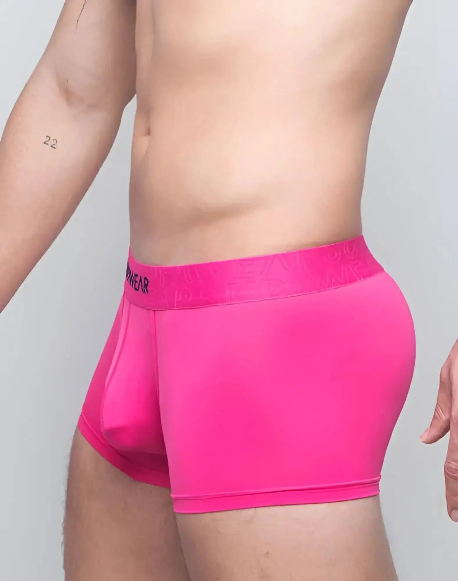 Bright pink supawear neon trunk underwear with matching elastic waistband featuring menwear branding in black lettering