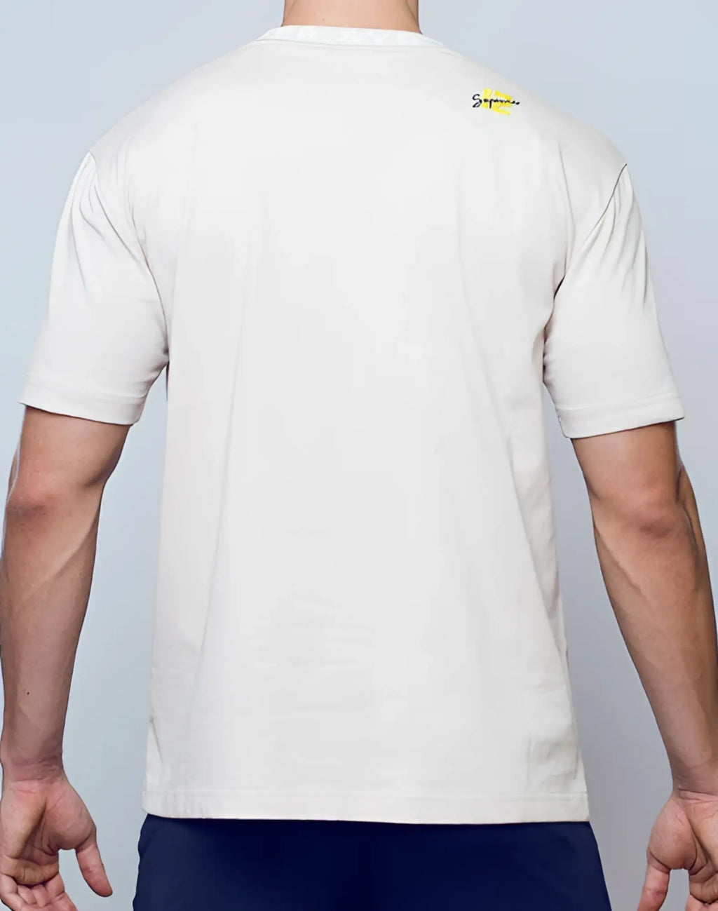 Off-white cotton supawear oversized tee moon beam beige with small yellow supreme logo on the upper back view