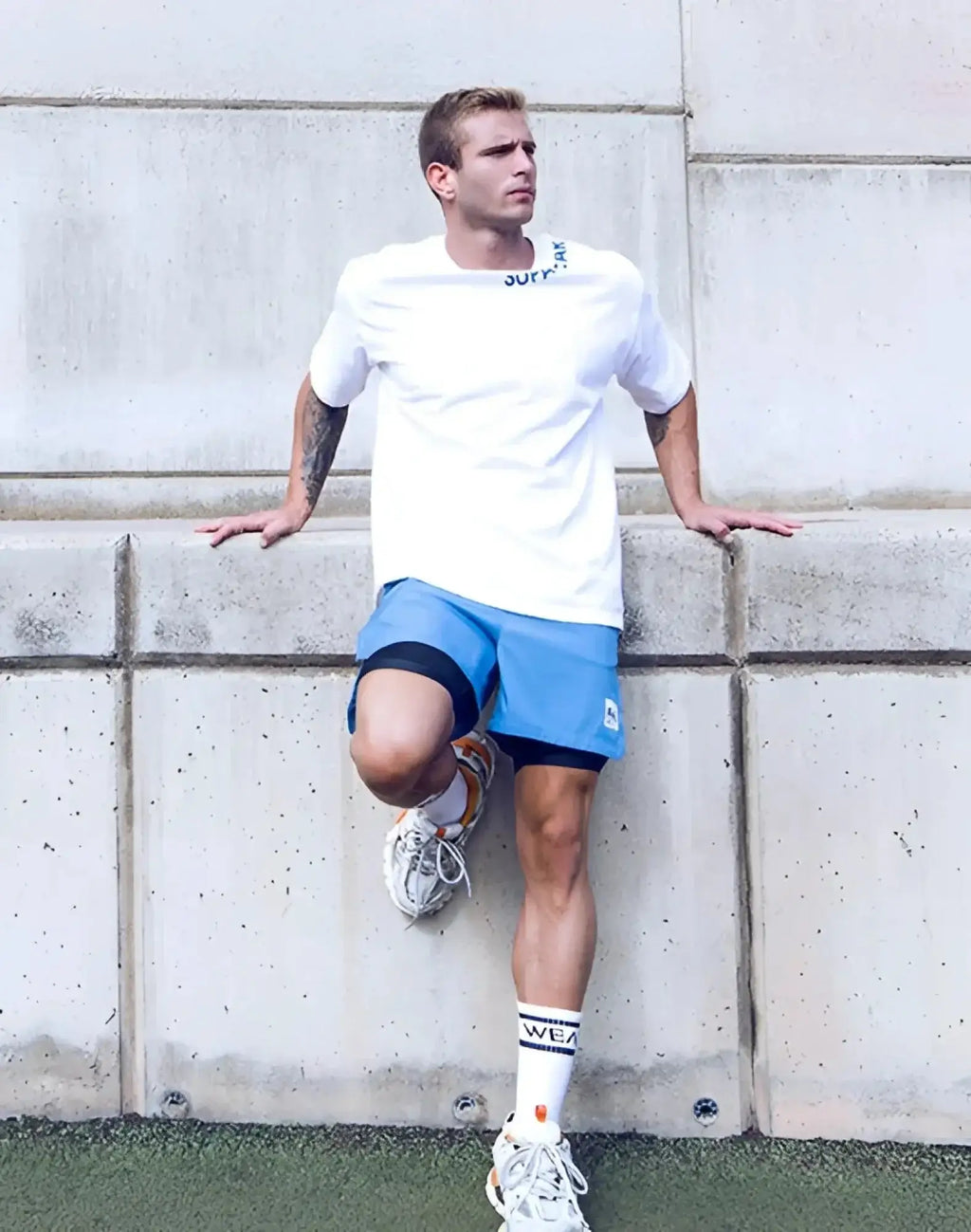 SupaWear oversized white short-sleeved tee with a subtle blue logo across the neckline in soft cotton fabric