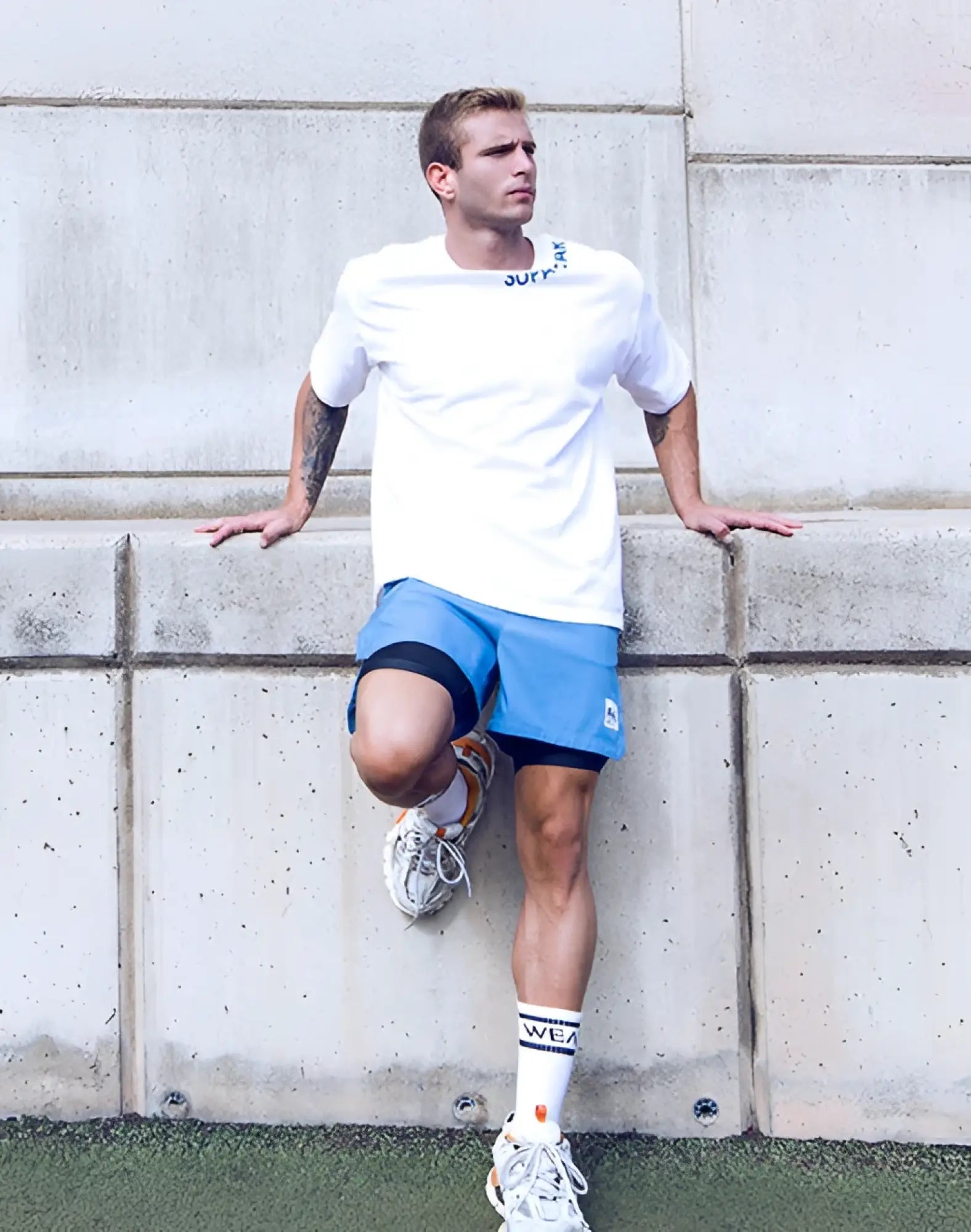SupaWear oversized white short-sleeved tee with a subtle blue logo across the neckline in soft cotton fabric
