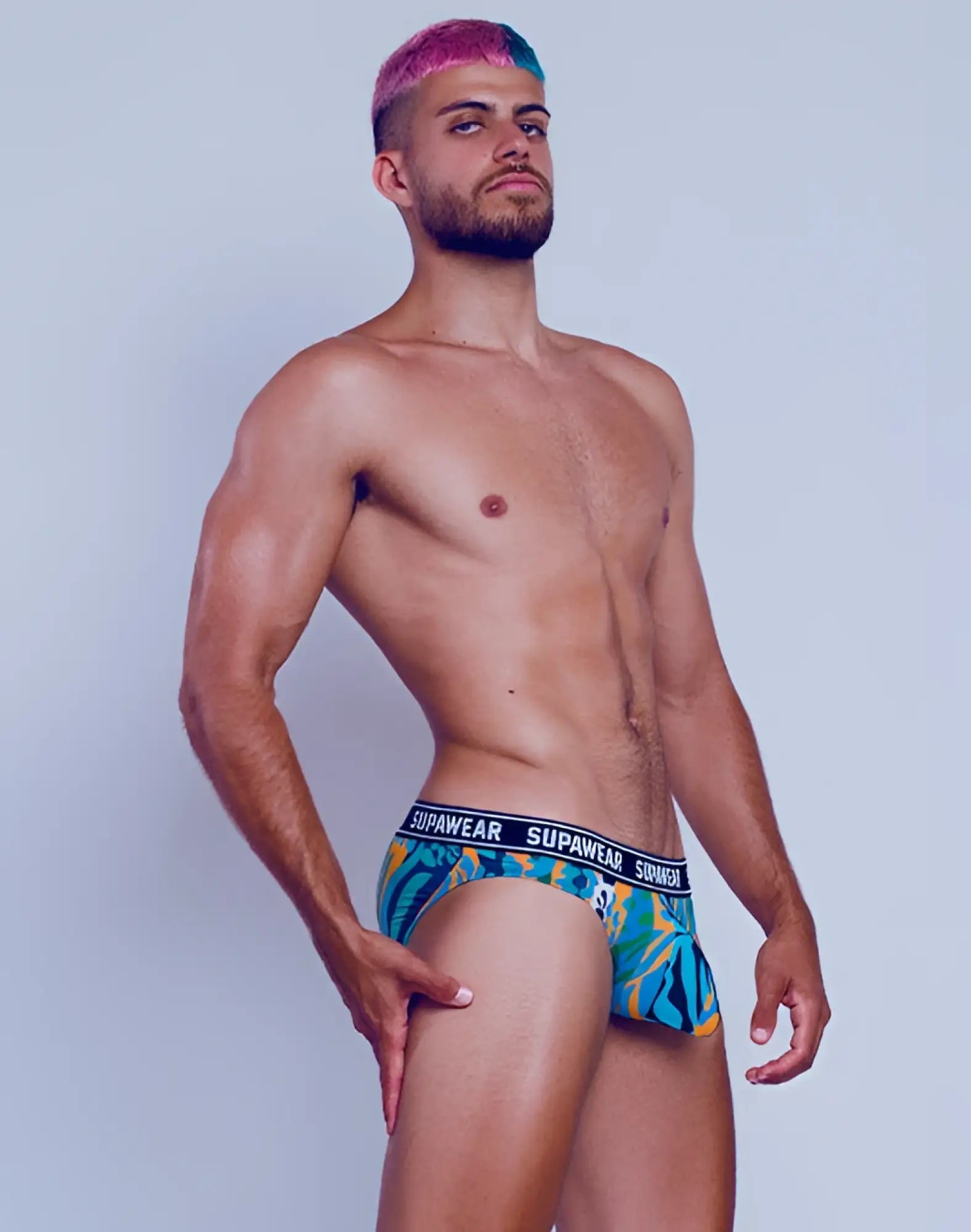 Blue and green tropical patterned supawear pow brief underwear with black waistband featuring brand name arctic animal