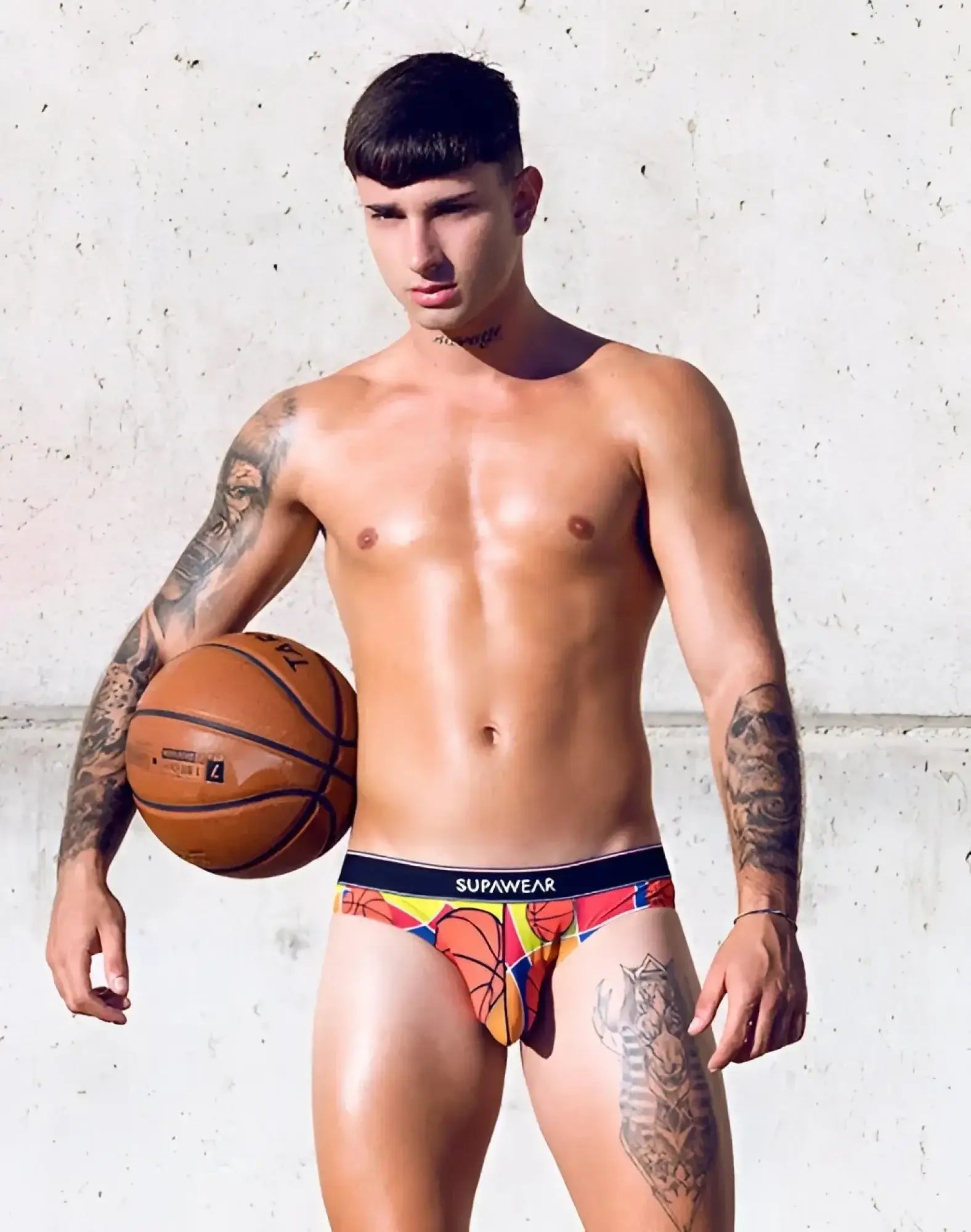 Colorful supawear pow brief underwear with vibrant orange and yellow basketball-themed graphic design