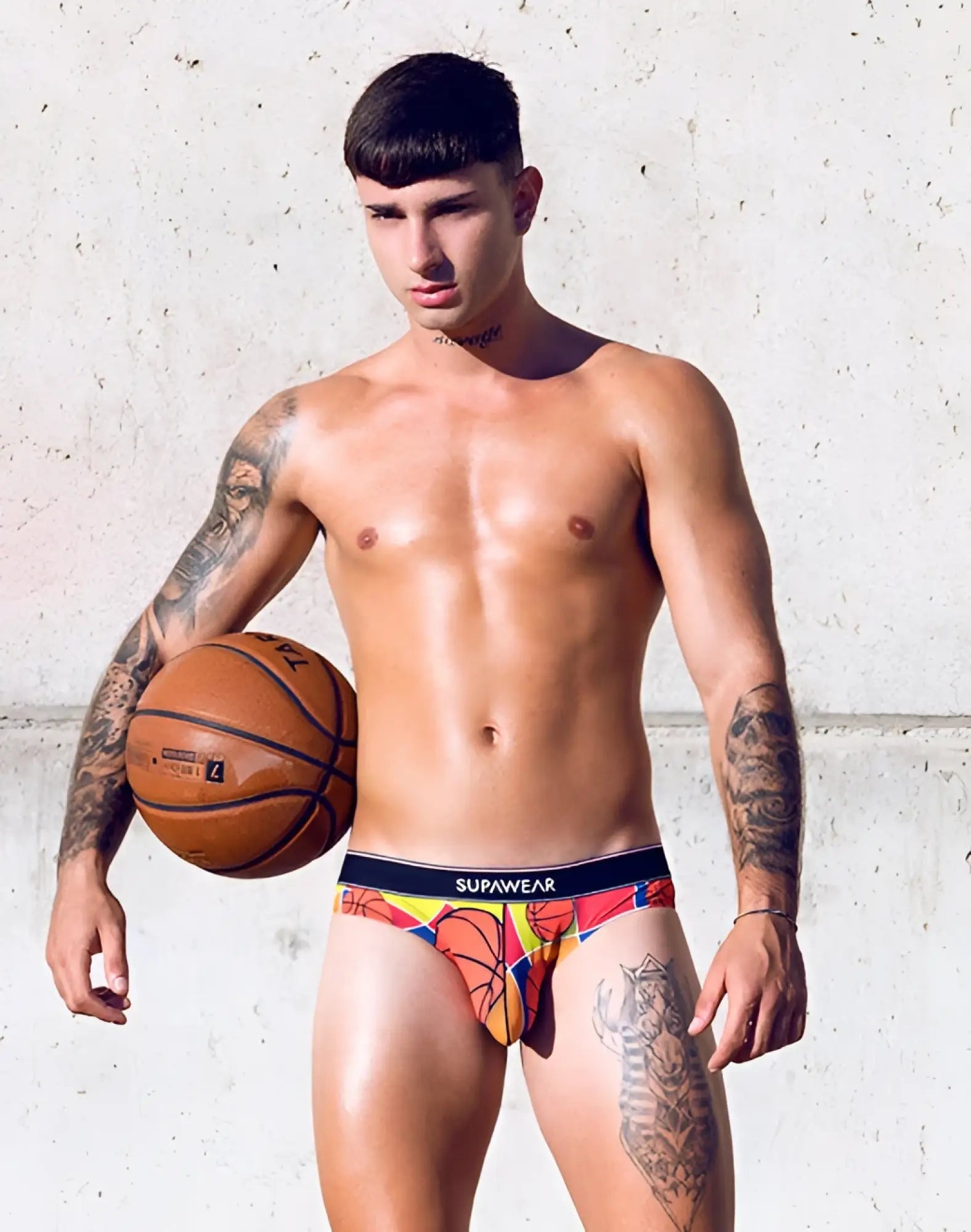 Colorful supawear pow brief underwear with vibrant orange and yellow basketball-themed graphic design