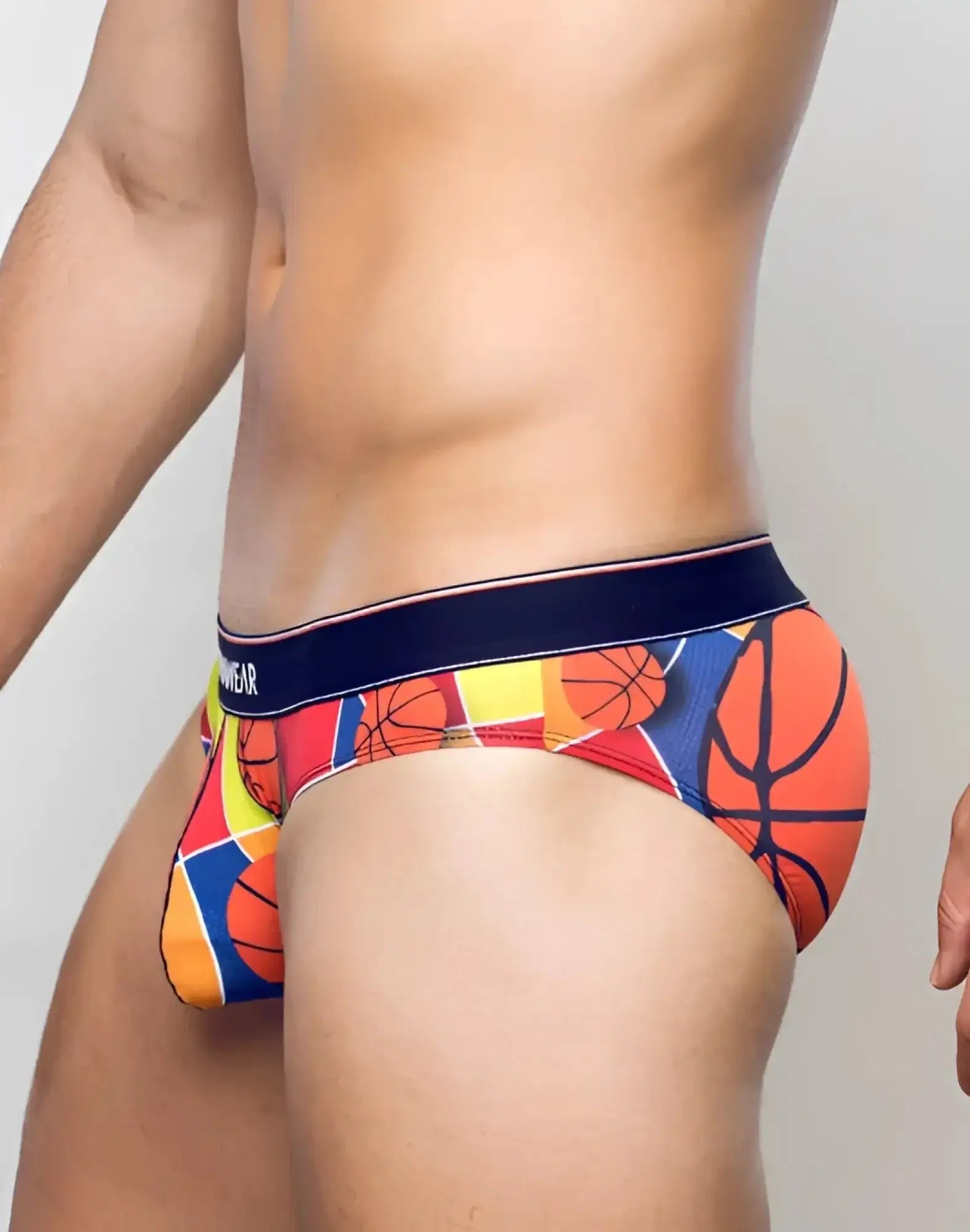 Vibrant supawear pow brief underwear with bold colorful geometric basketball pattern in orange red yellow and blue