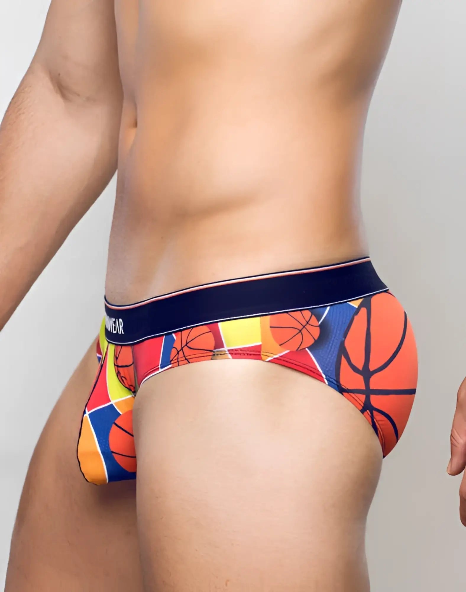 Vibrant supawear pow brief underwear with bold colorful geometric basketball pattern in orange red yellow and blue