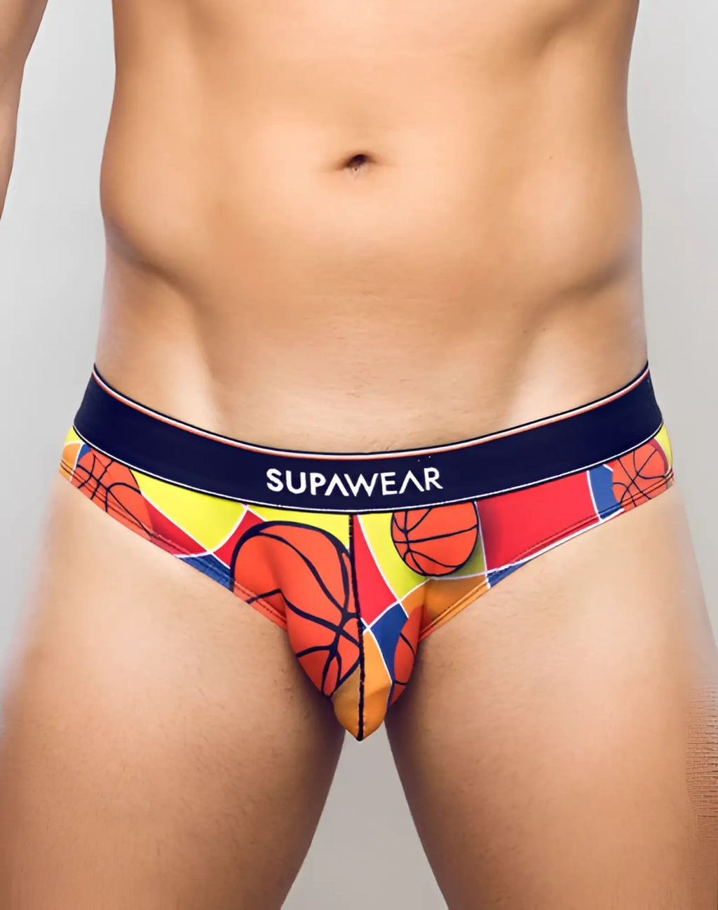 Vibrant basketball-themed men’s briefs in bold red yellow and orange with navy supawear waistband balls design