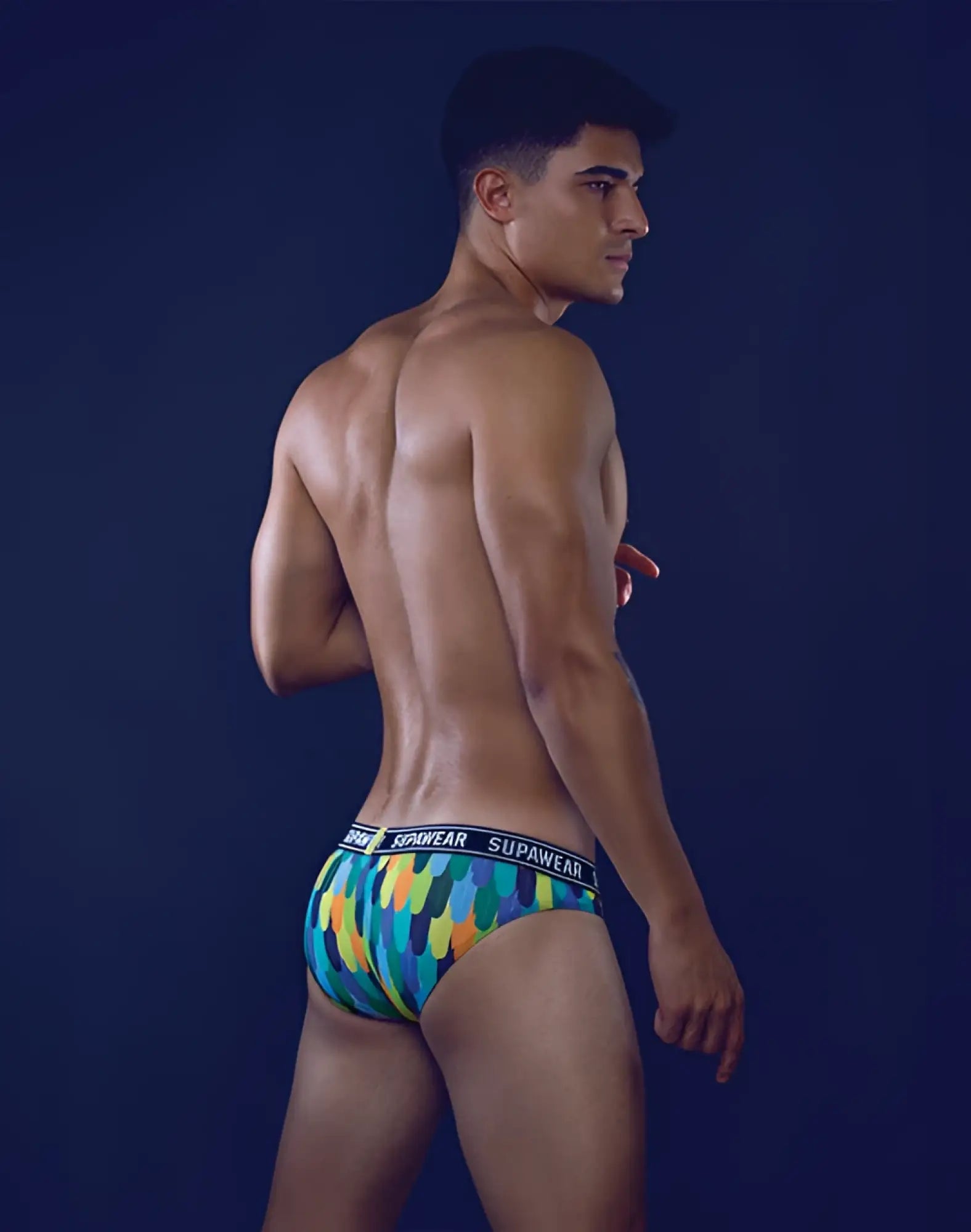 Vibrant multicolored geometric-patterned supawear pow brief underwear with black elastic waistband in peacock colors