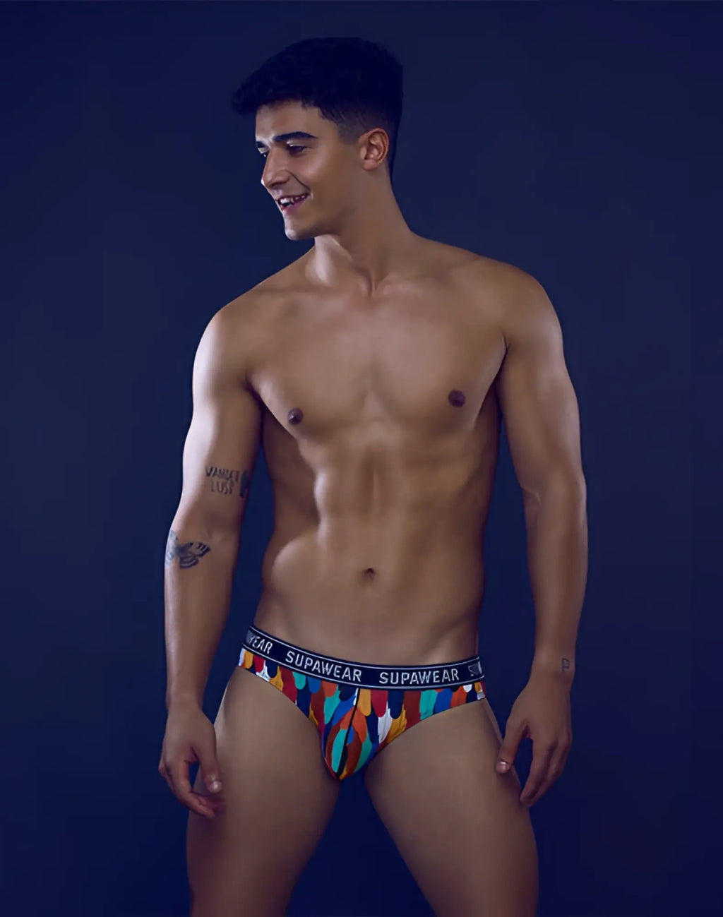 Colorful patterned supawear pow brief underwear with black waistband featuring supawear brand name rooster design