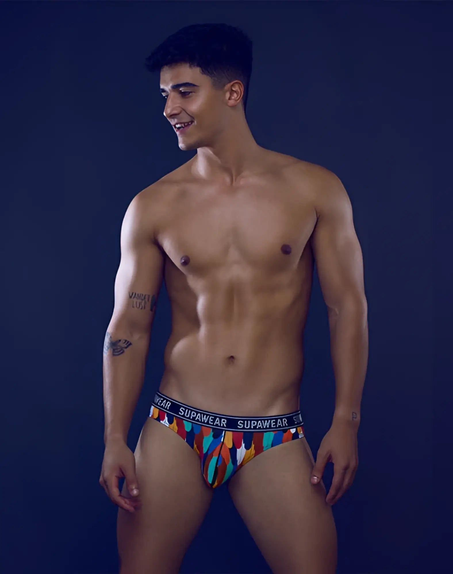 Colorful patterned supawear pow brief underwear with black waistband featuring supawear brand name rooster design