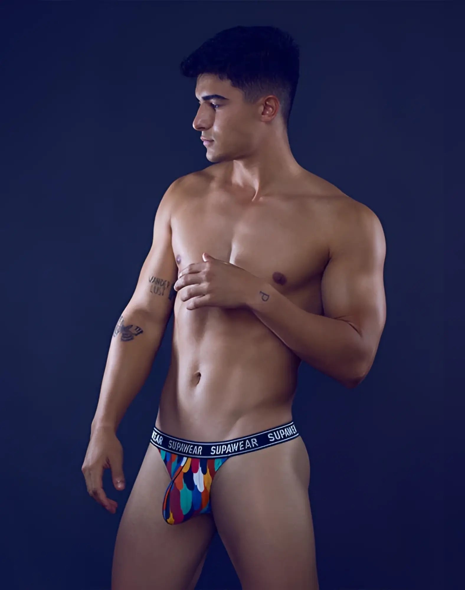 Colorful patterned supawear pow thong underwear with blue elastic waistband and white brand name lettering
