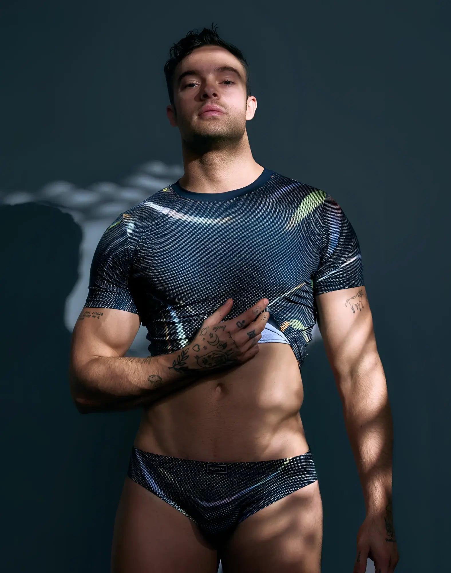 Dark blue textured short sleeve crop t shirt with iridescent swirls and subtle sheen by supawear printed pride