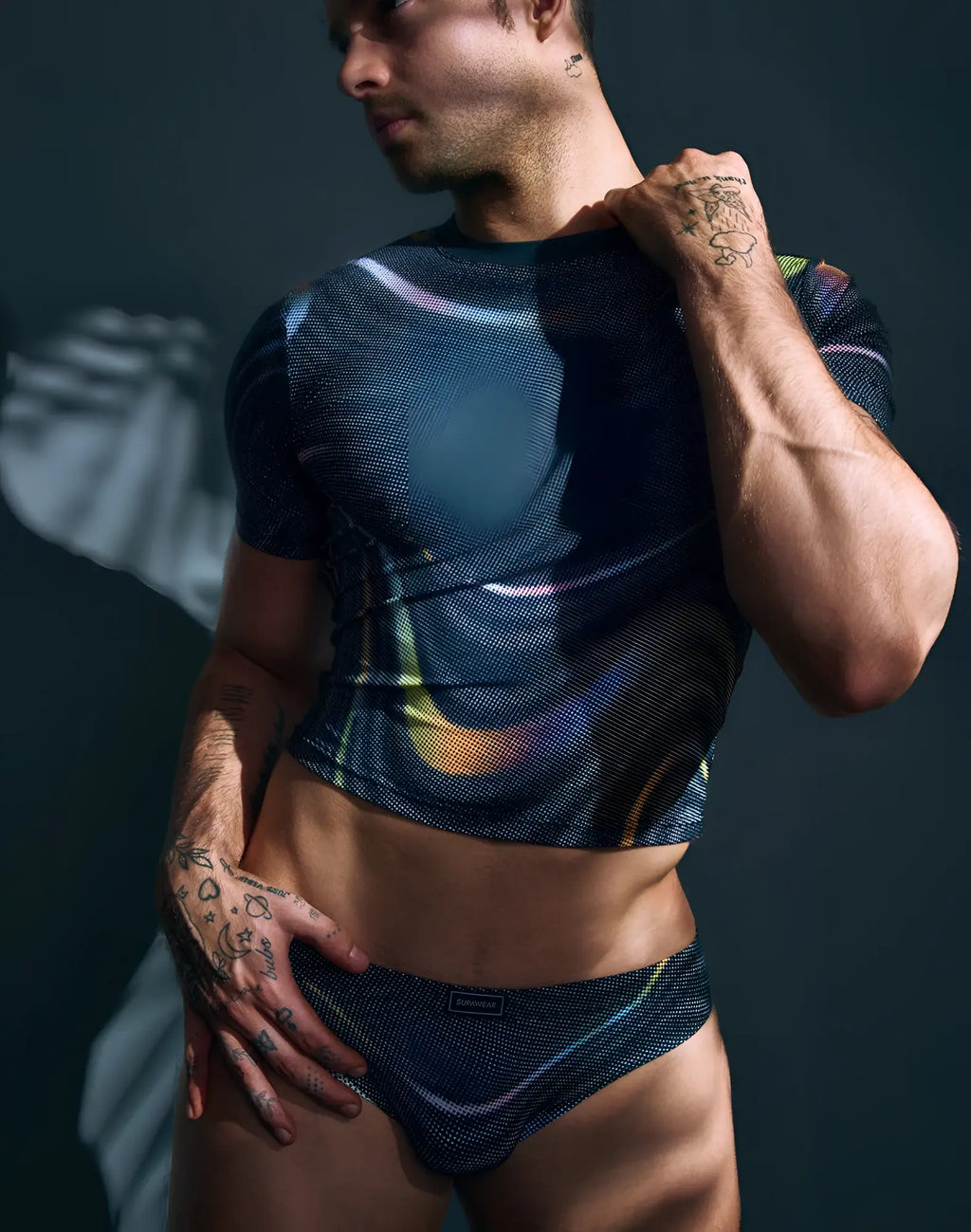 SupaWear printed pride crop t-shirt in black mesh with iridescent rainbow swirls and matching black mesh briefs