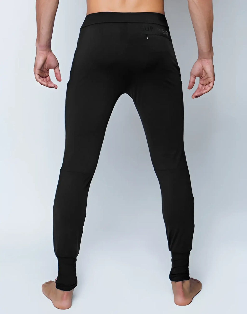 Black SUPAWEAR pro-training leggings with snug fit and subtle waistband branding for athletic performance