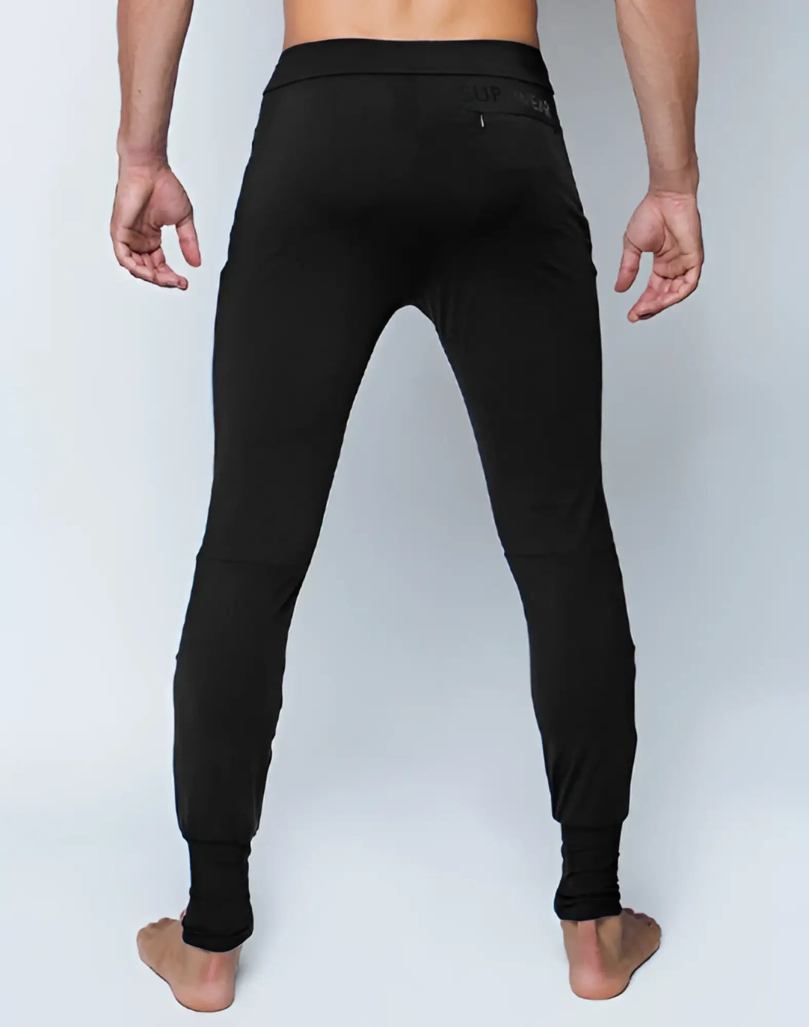 Black SUPAWEAR pro-training leggings with snug fit and subtle waistband branding for athletic performance