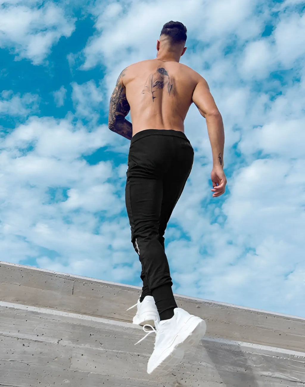 Black form-fitting SUPAWEAR Pro-Training Pants with sleek design and subtle side zipper details for active wear