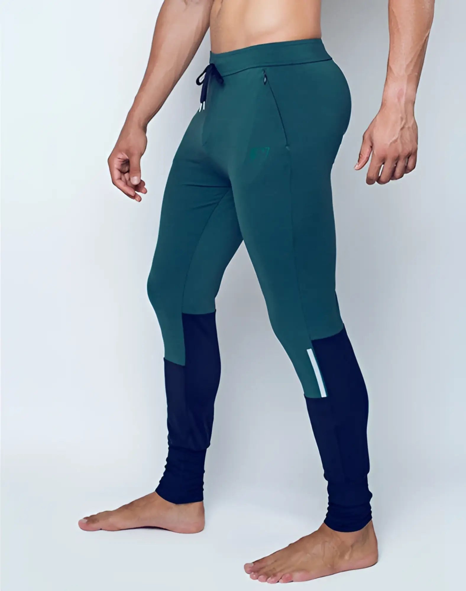 SupaWear pro-training pants in dark green and navy blue with a subtle white side stripe for athletic use