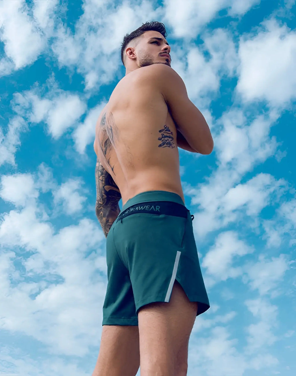 Dark green supawear pro-training athletic shorts with black waistband logo and white side stripes for active use