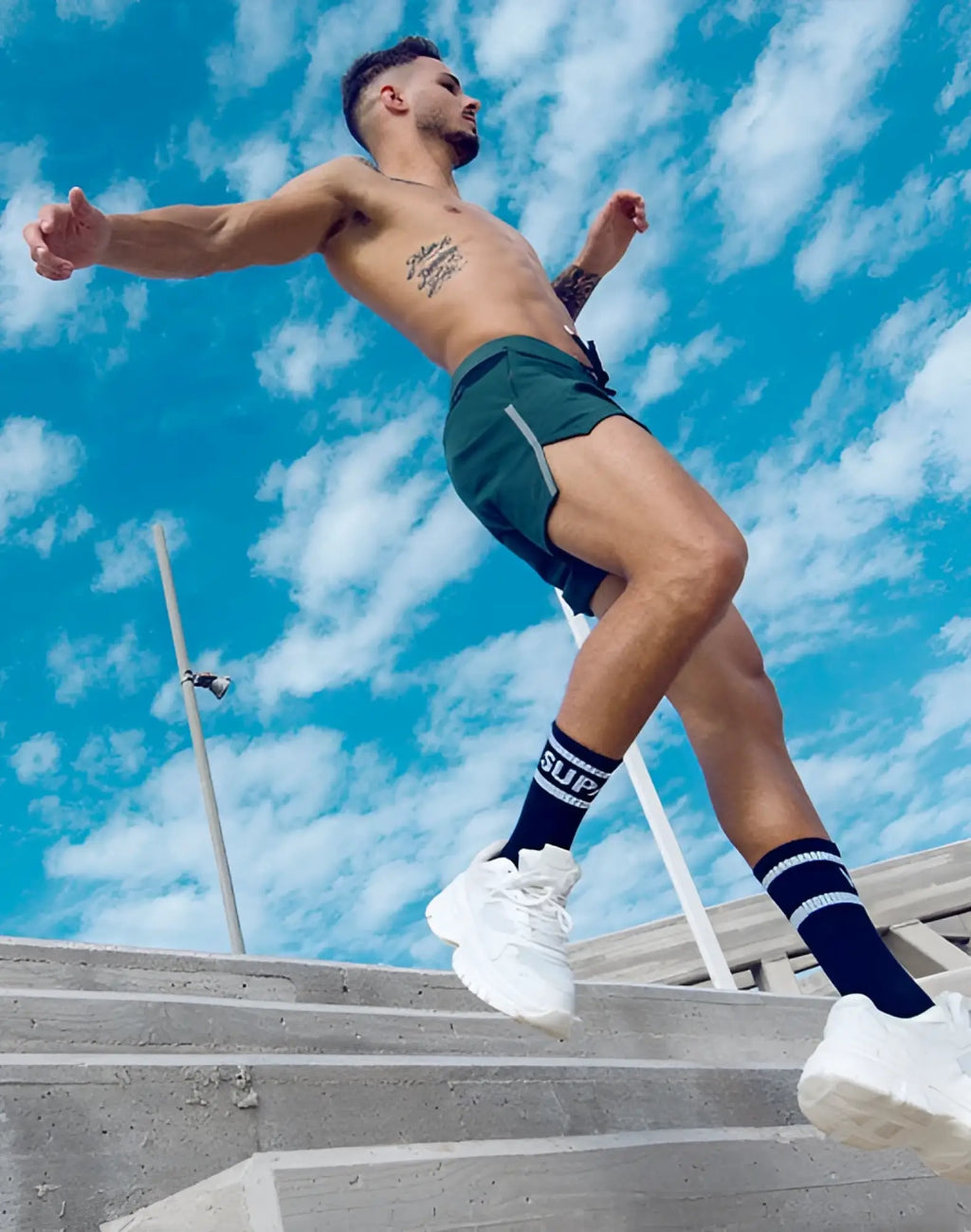 White chunky sole sneakers paired with supawear pro-training shorts in boost green for active wear