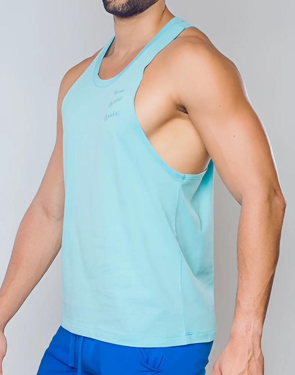Light blue sleeveless tank top with subtle embroidered supawear logo on chest in racer back singlet style