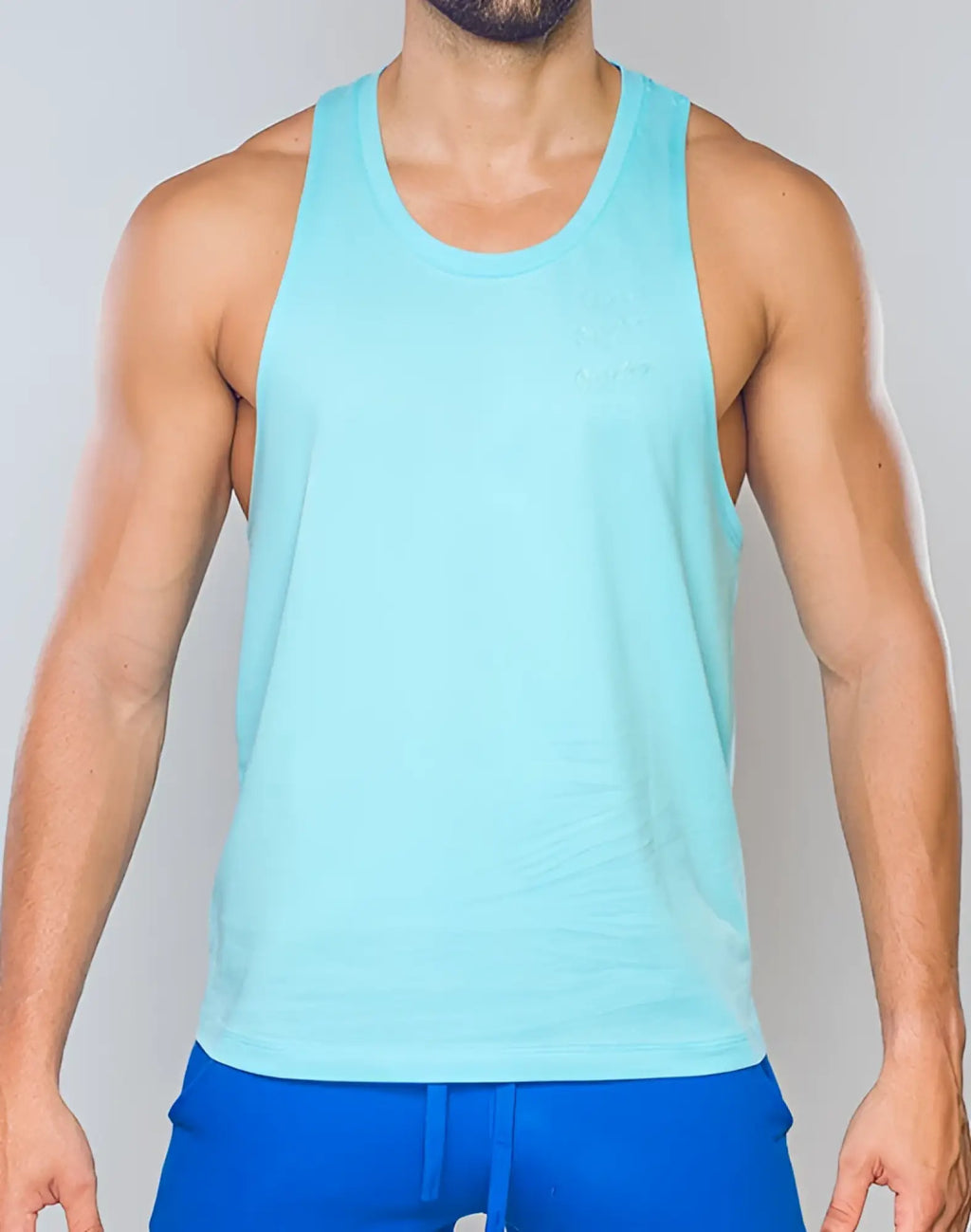 Light blue sleeveless SUPAWEAR racer back singlet with subtle embroidered chest design in turquoise blue