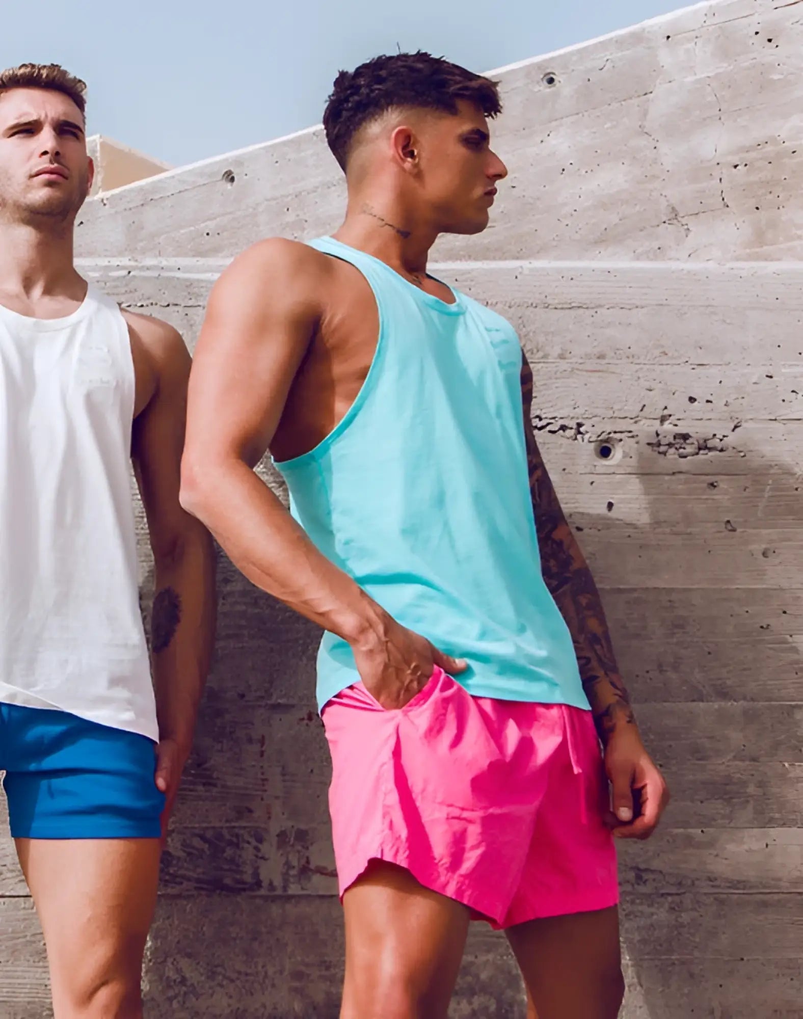 A vibrant turquoise blue supawear racer back singlet with a sleeveless tank top design and clean style