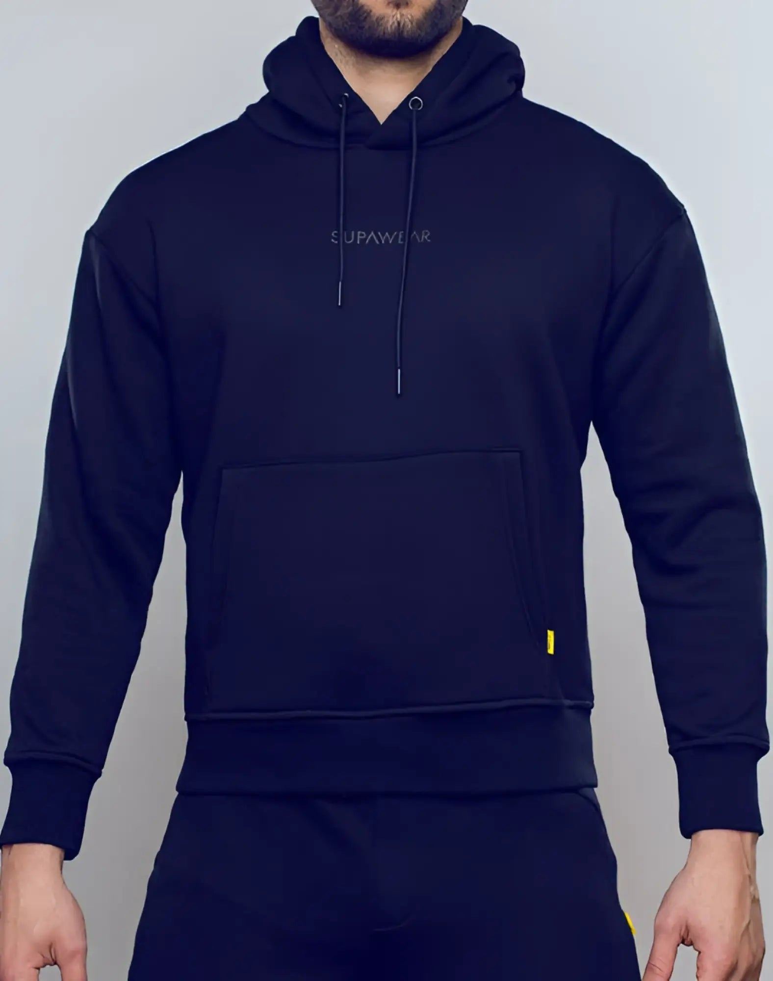 Black supawear recovery hoodie with subtle embroidered logo and yellow zipper pull for comfortable casual wear