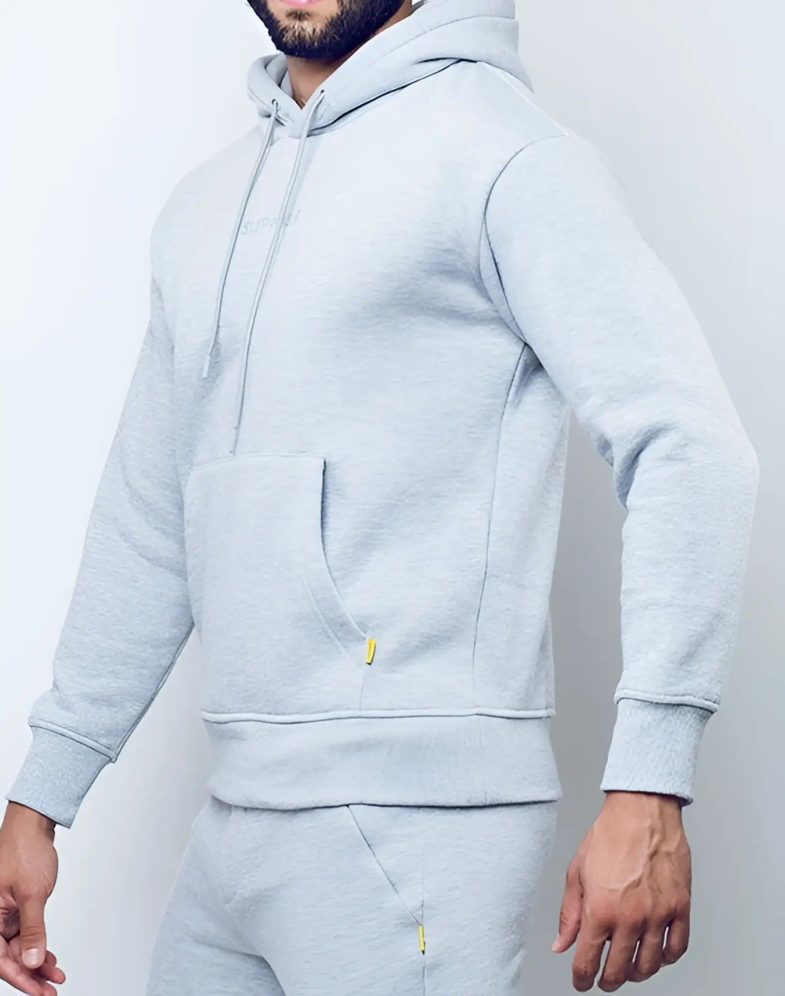SupaWear recovery hoodie in grey marle with subtle yellow zipper pulls and a small embroidered chest logo