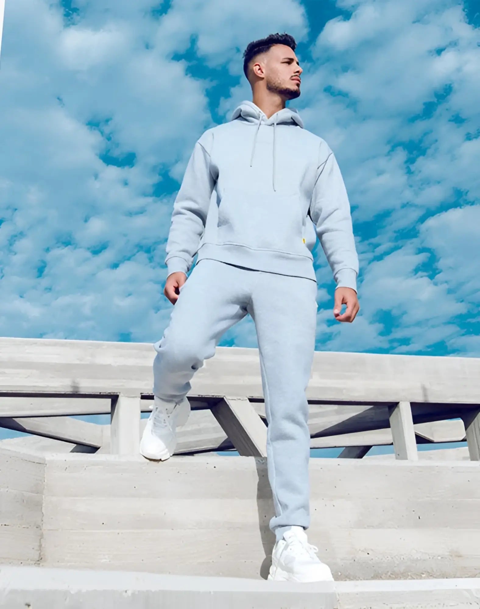 Light gray Supawear recovery hoodie with matching joggers and white sneakers in a casual athletic set