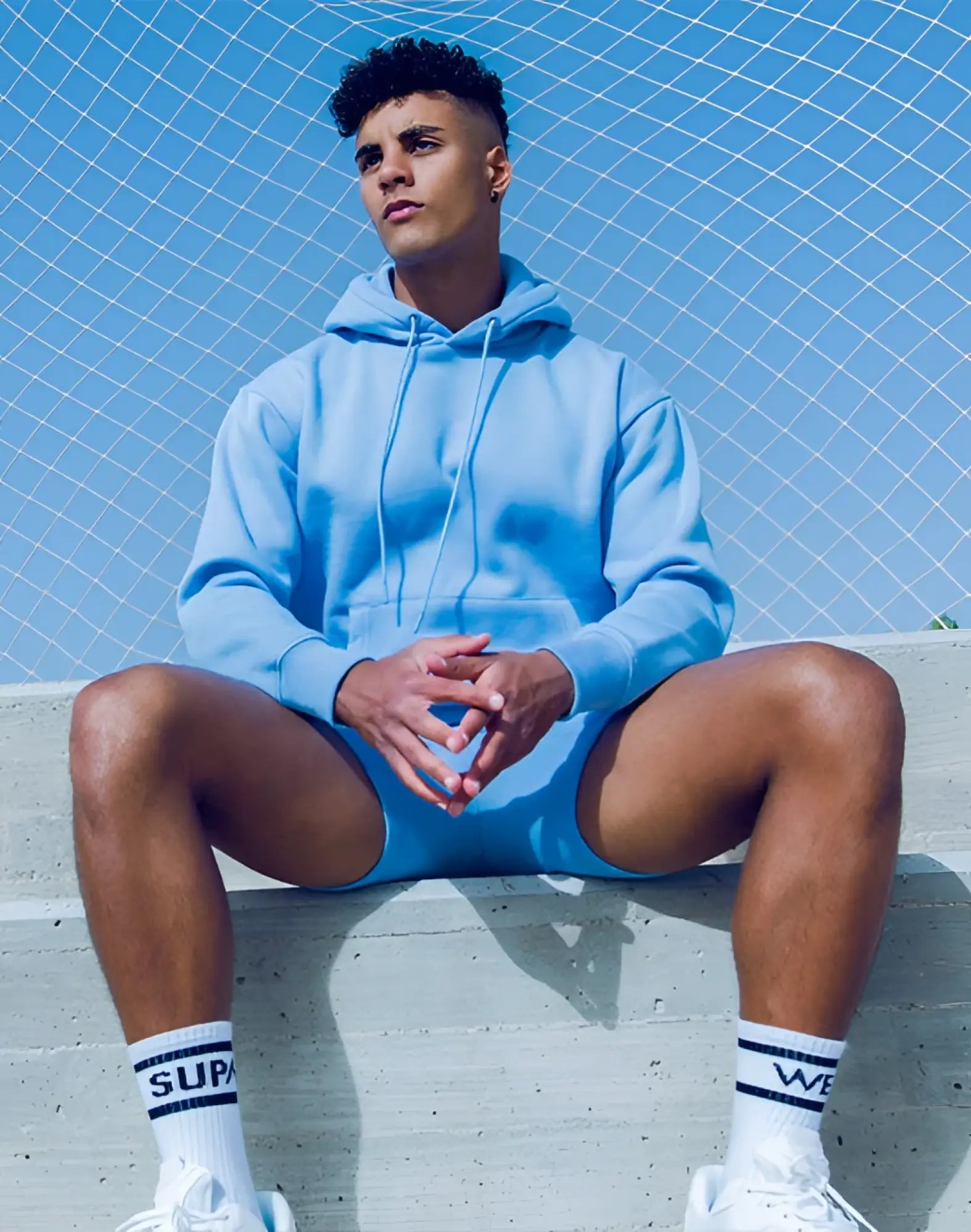 Light blue supawear recovery hoodie with hood drawstrings and front pocket for comfortable casual wear