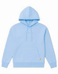 Light blue SUPAWEAR recovery hoodie with subtle gray embroidered logo and small yellow tag on lower right sleeve