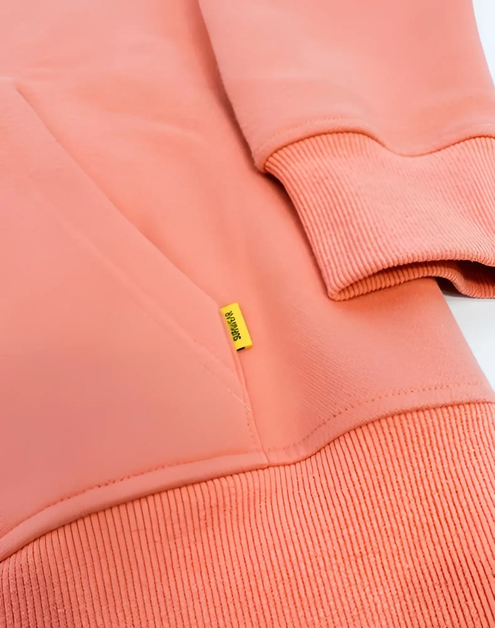 Coral-colored cotton supawear recovery hoodie reboot clay with ribbed cuffs hem and small yellow brand tag