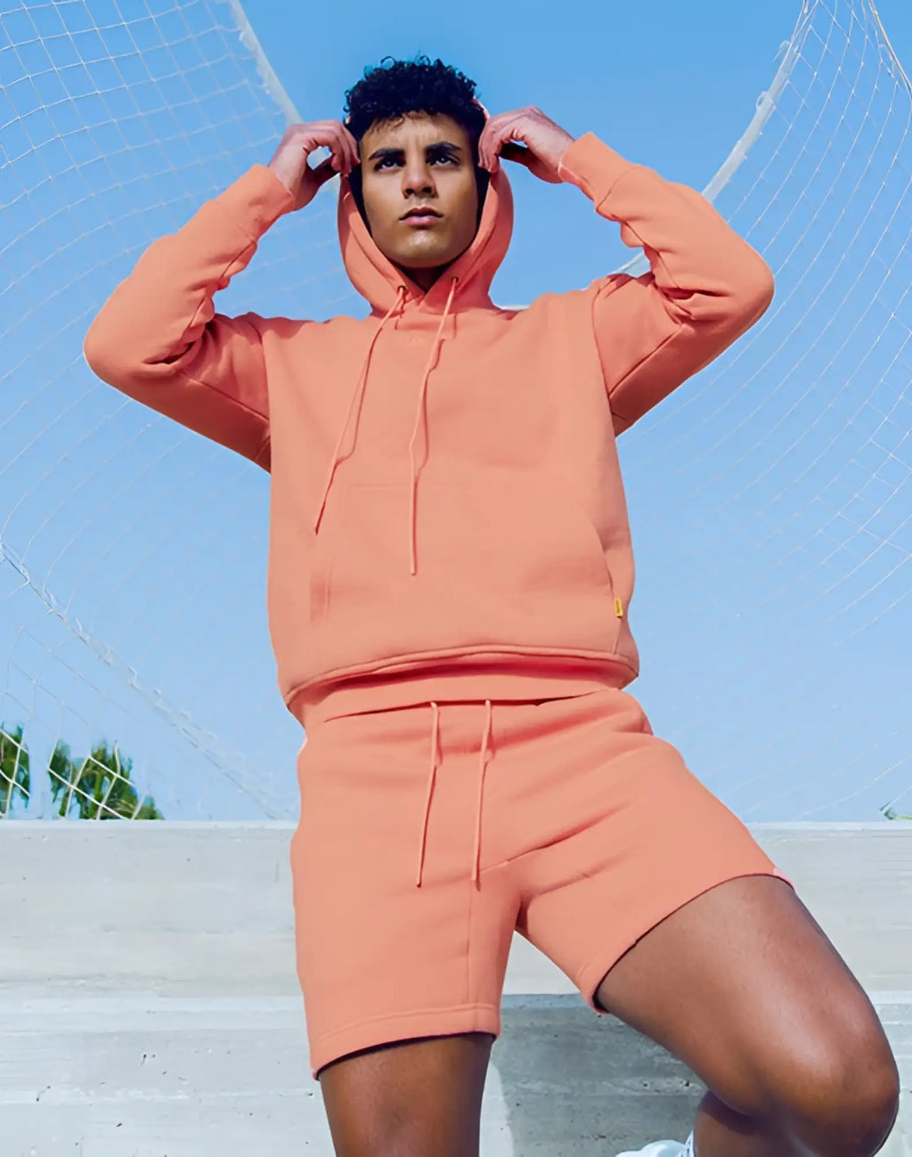 Coral-orange supawear recovery hoodie with hood and matching drawstring shorts in soft reboot clay fabric