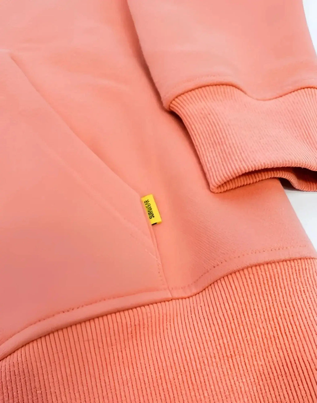 Coral-colored cotton supawear recovery hoodie reboot clay with ribbed cuffs hem and small yellow brand tag